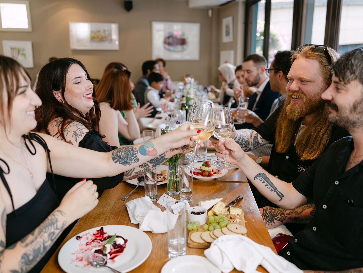Guests raise glasses in a toast during an indoor celebration.