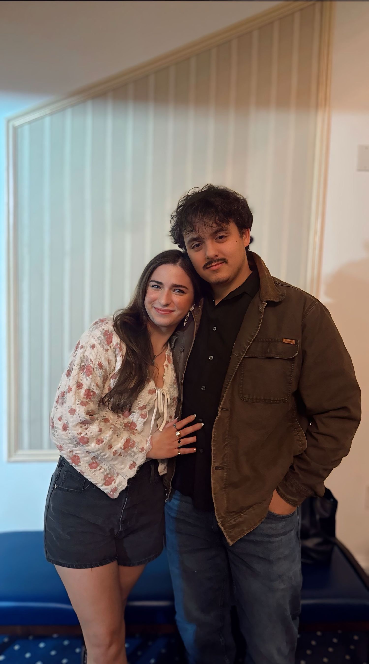 Photographer and partner posing together indoors, smiling and close, Rhen Marie Photography