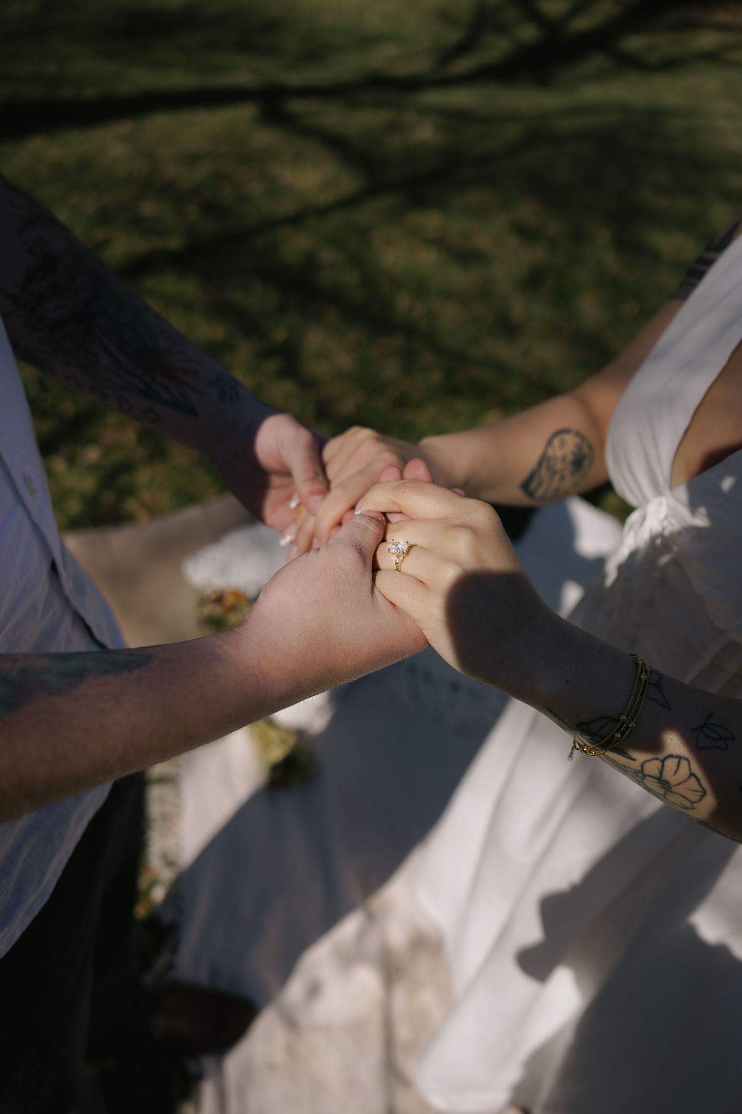 Close-up of couple holding hands outdoors in the DMV, capturing intimate connection and rinduring engagement session, Rhen Marie Photography