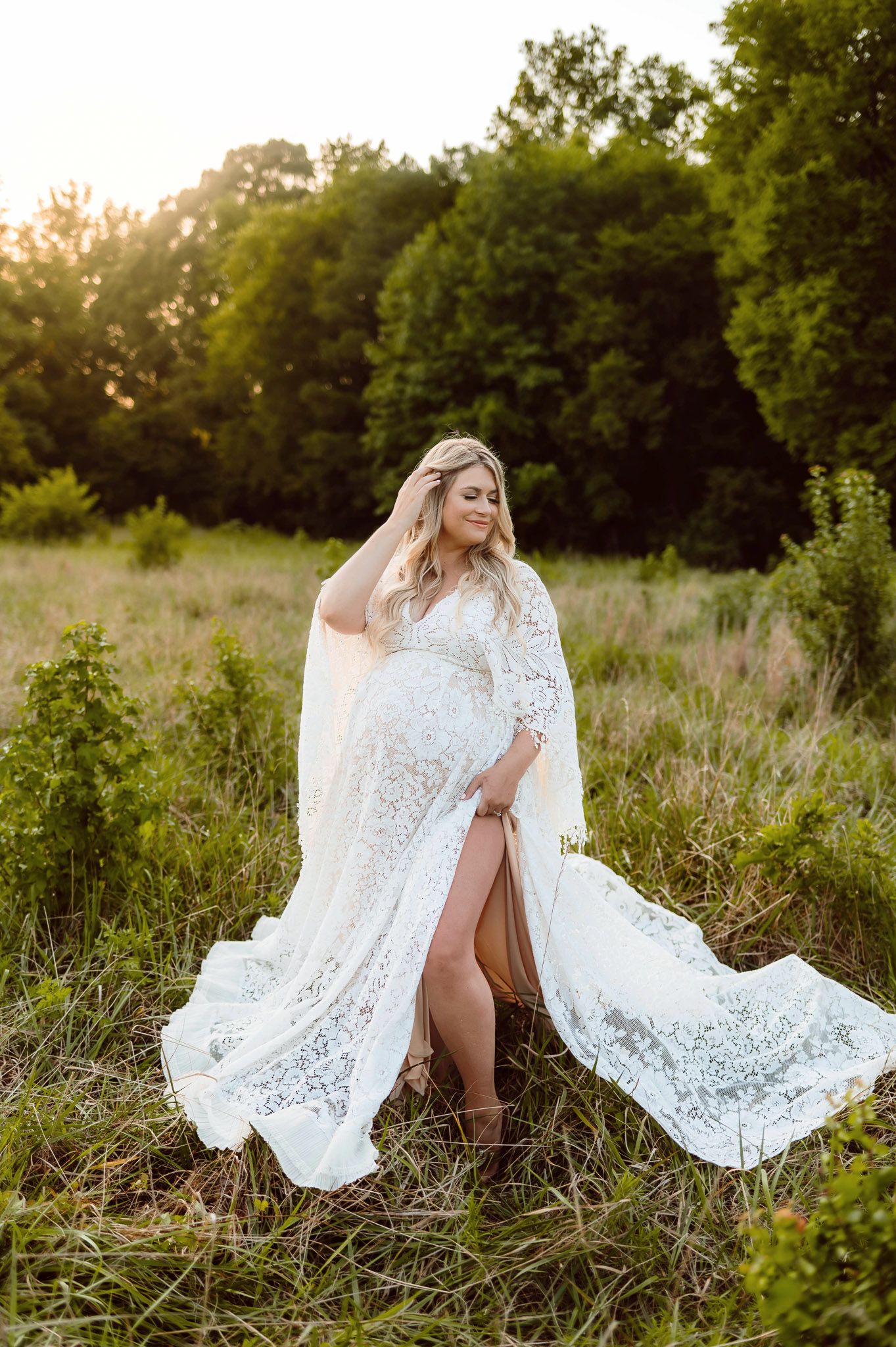 Expectant mother in a flowing lace dress during a golden hour maternity photography session in Raleigh North Carolina