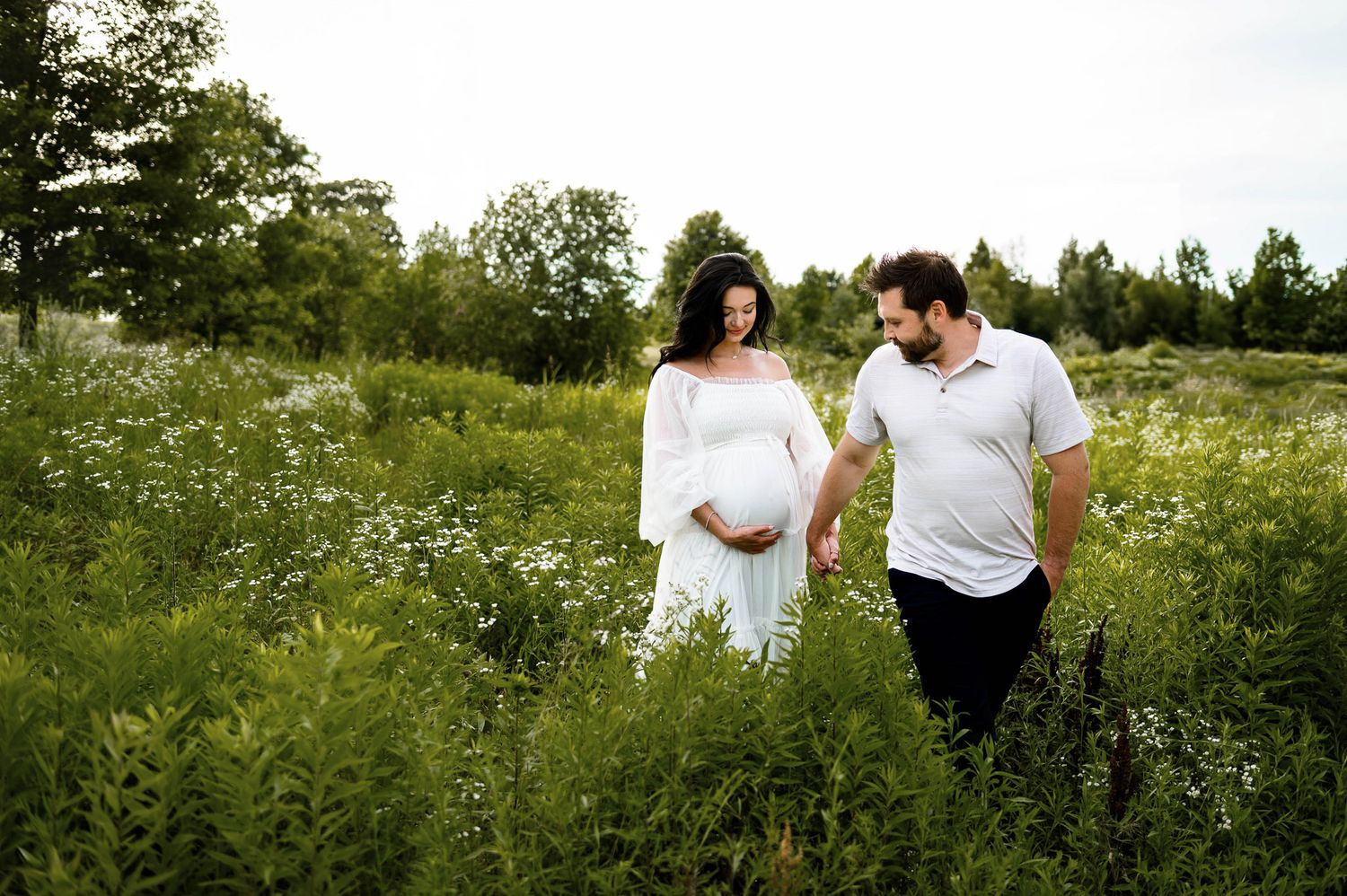 Family maternity photography session with parents and young son during an outdoor Raleigh maternity photography session