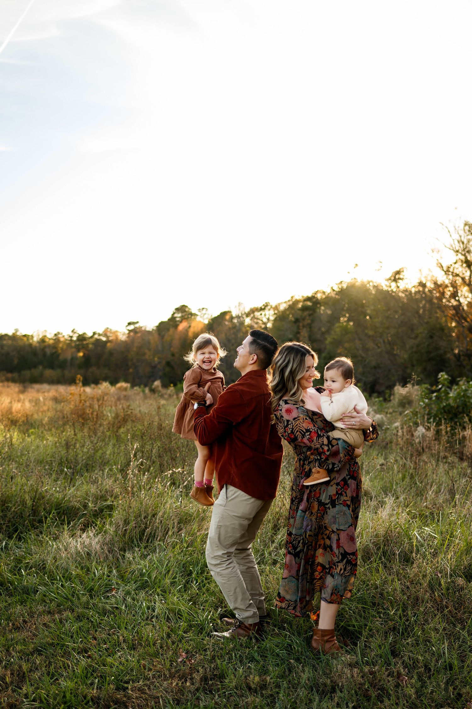 Family with two young children during a golden hour family photography session at Horseshoe Farm Nature Preserve near Raleigh NC