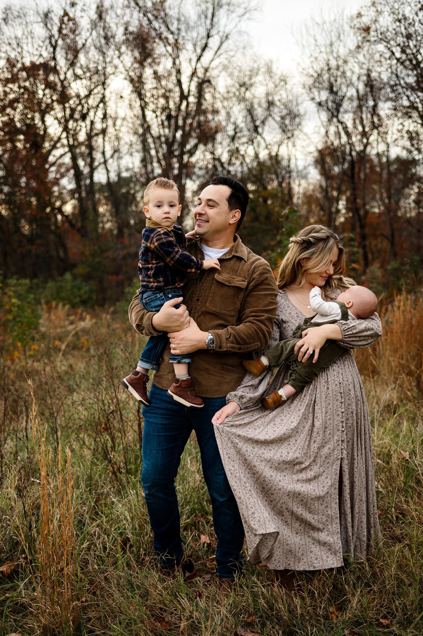 Parents holding their children during a candid fall family photography session in Raleigh North Carolina