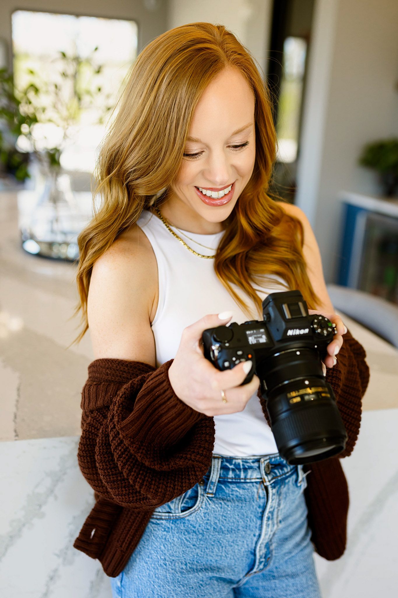 Raleigh family photographer Emma Branch reviewing photos on camera during lifestyle photography session