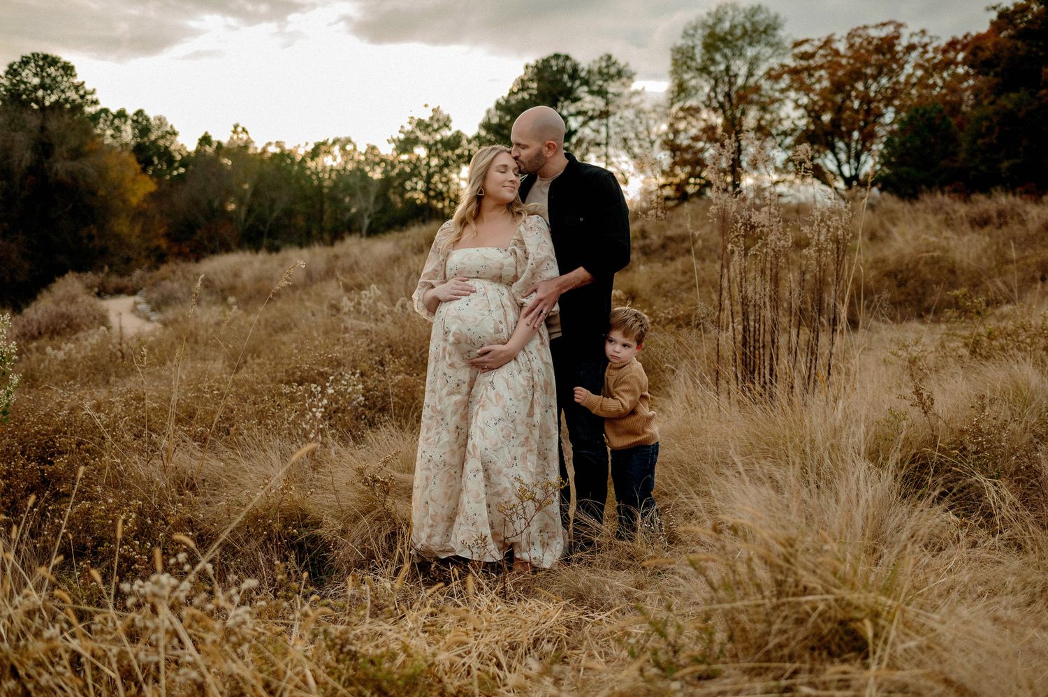 Expectant parents embracing during a golden hour maternity photography session in Wake Forest NC