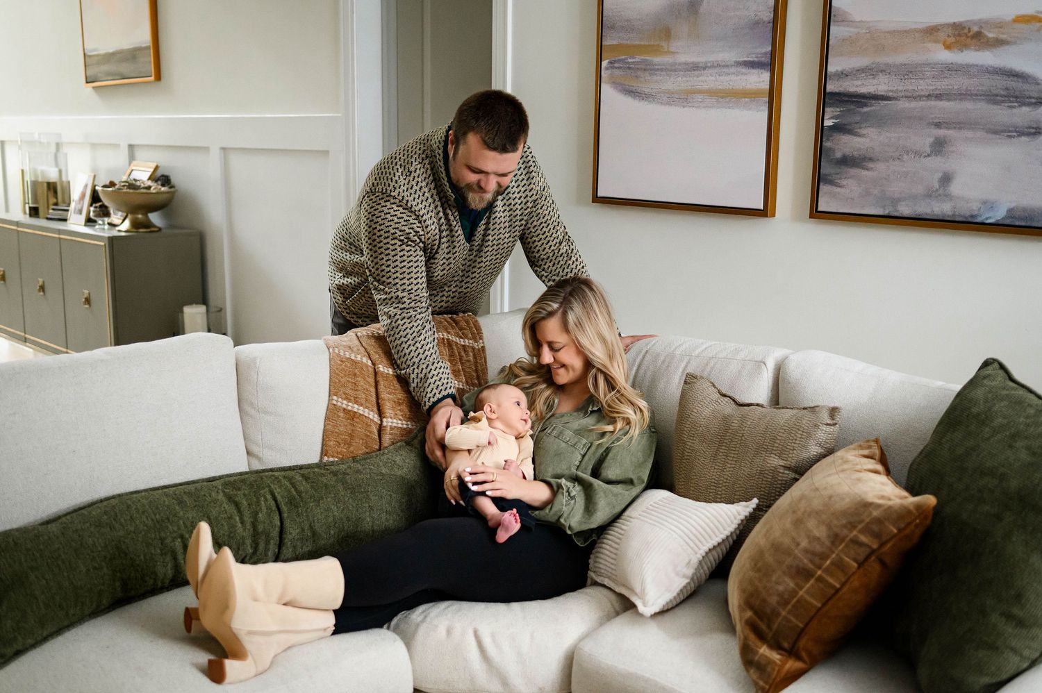 Parents sharing a cozy moment with their baby during an in-home family photography session in Raleigh NC