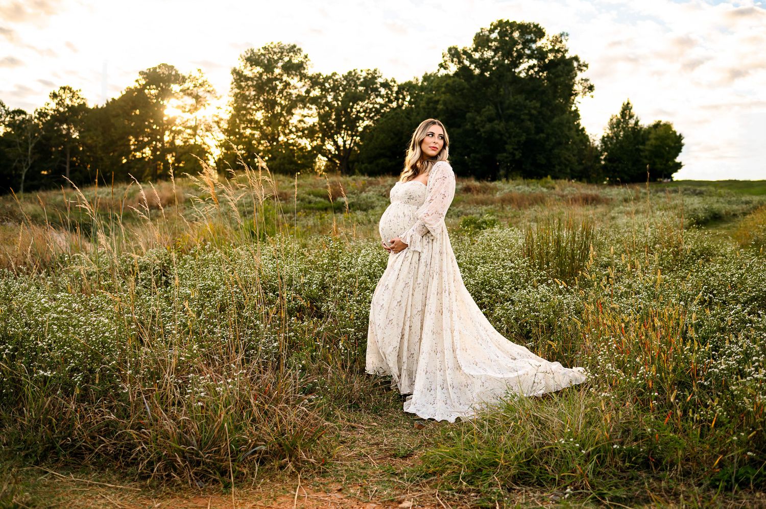 Pregnant mother wearing a flowing dress during an outdoor maternity photography session in Raleigh North Carolina