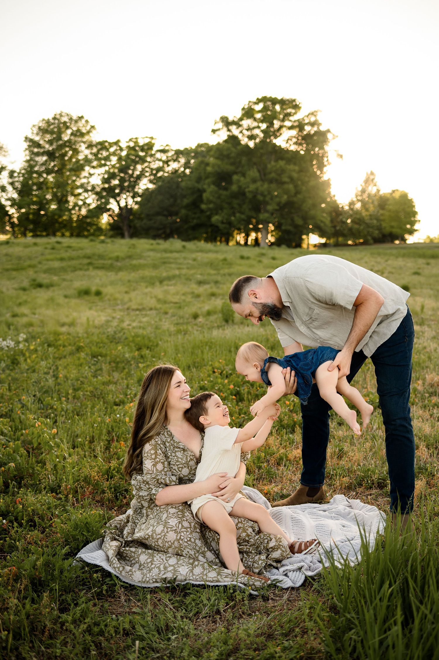 Parents and two children enjoy a playful moment together during family photography session with Raleigh family photographer