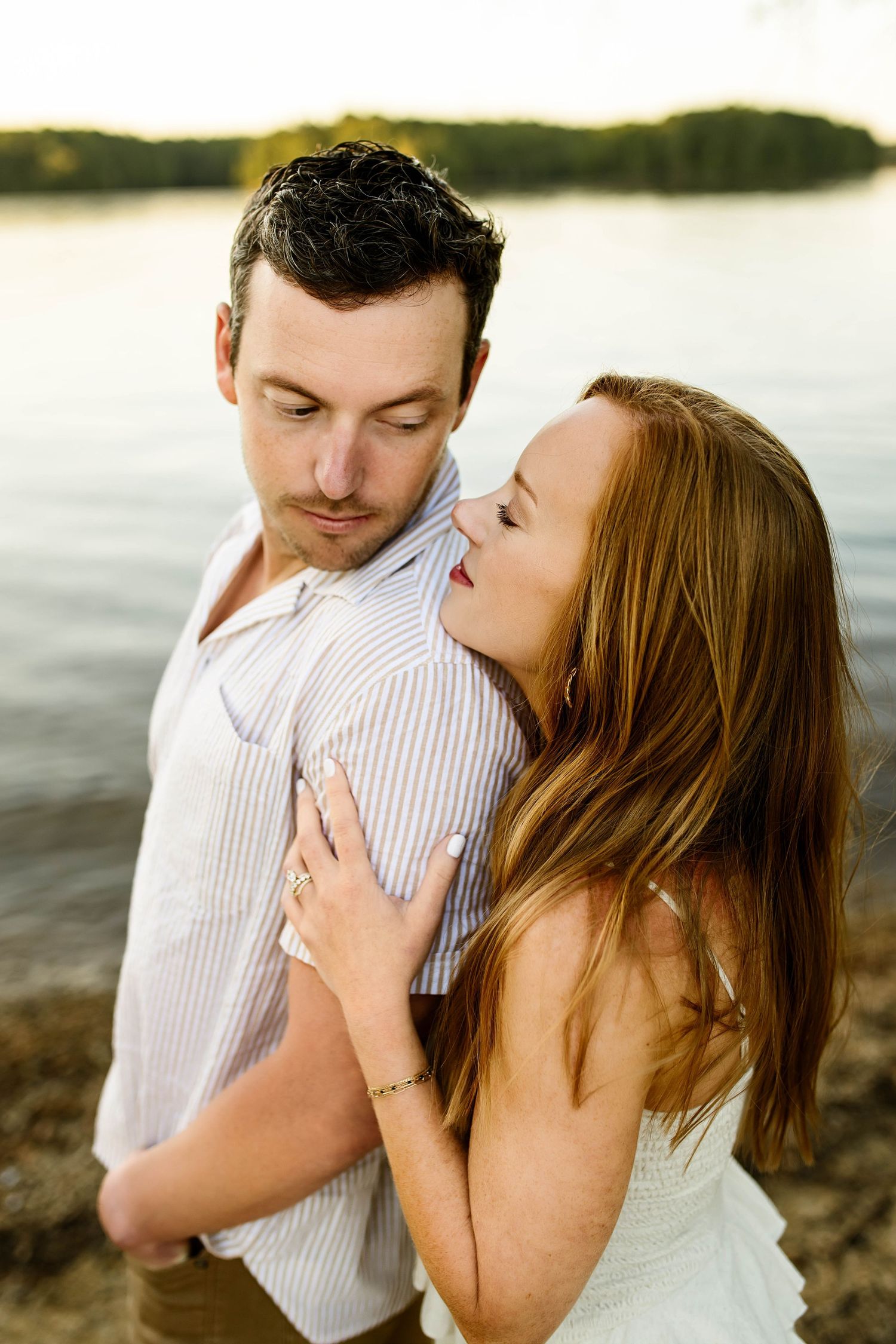 A romantic couple embraces on a beach during sunset sharing tender moments in a series of intimate photographs with Emma Branch Photography
