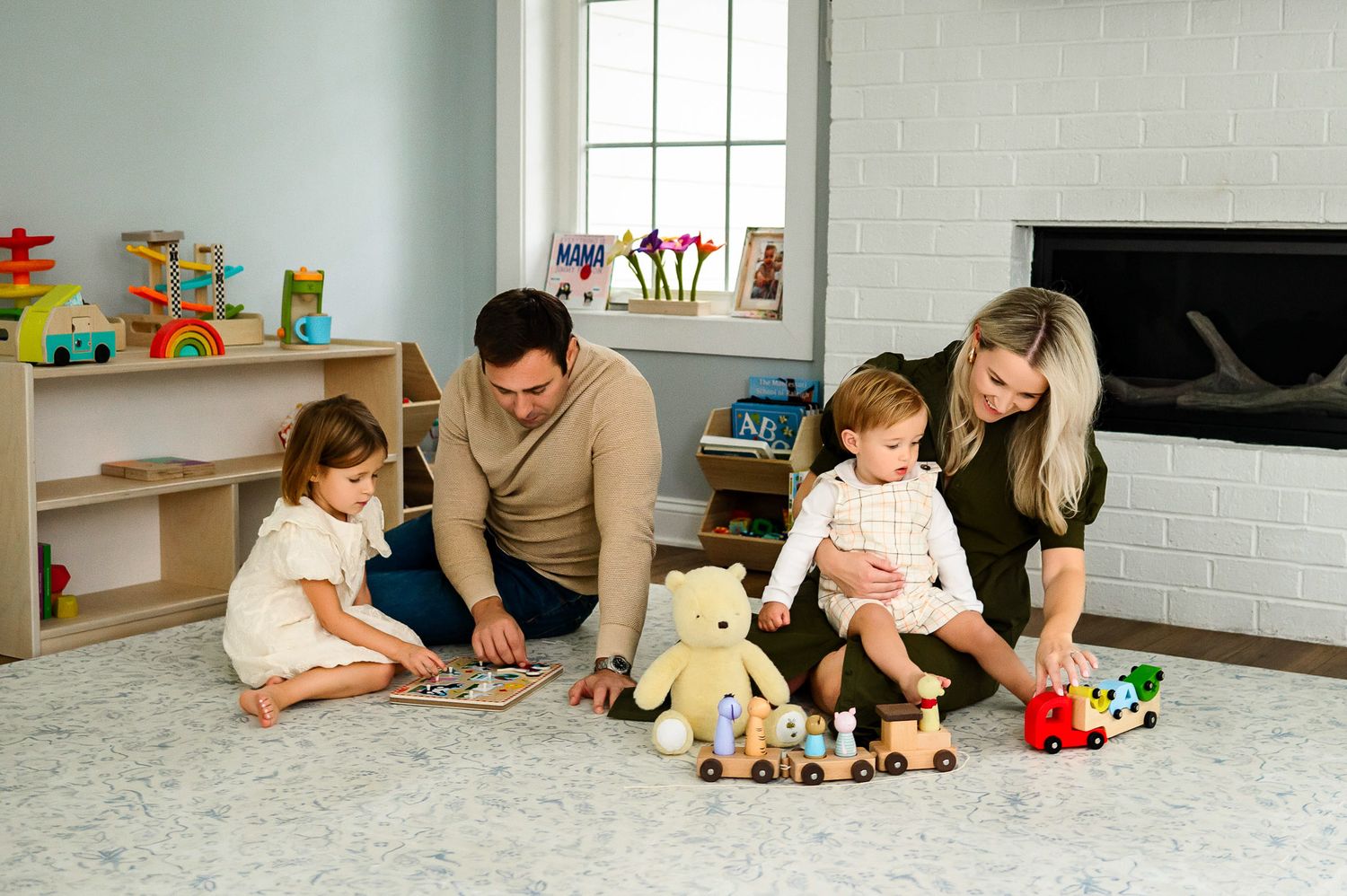 Parents and children playing together during relaxed in home lifestyle family photography session in Wake Forest NC