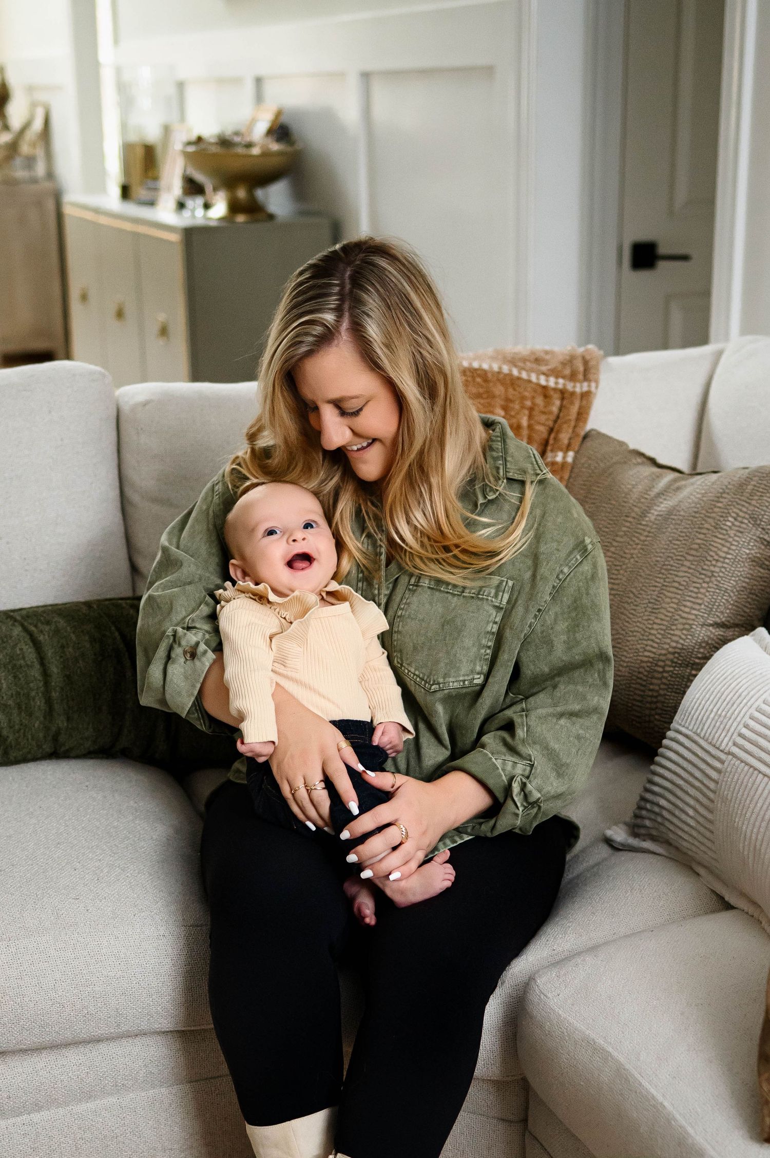 Mother holding her baby during an in-home family photography session in Raleigh NC