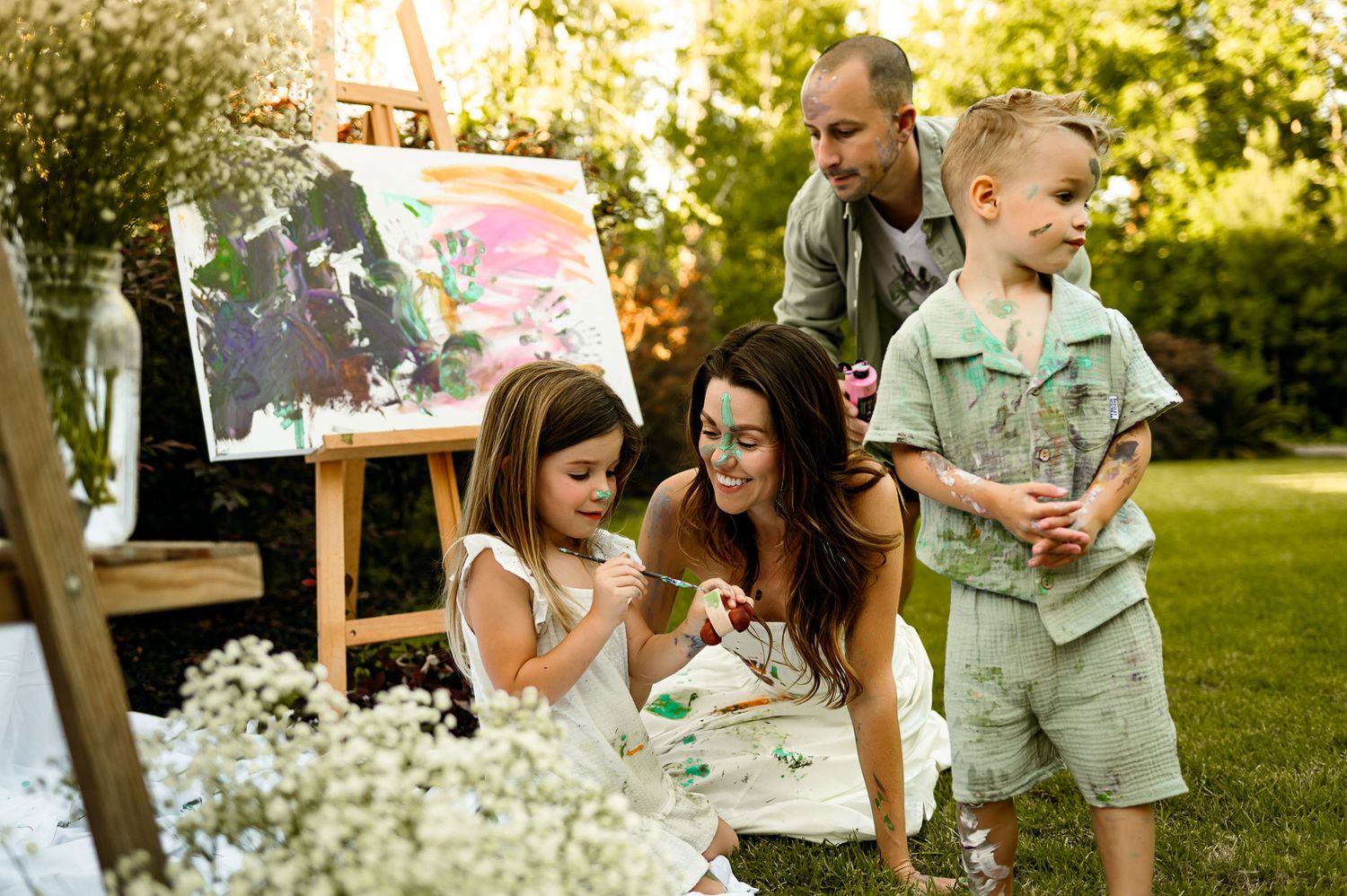 Mother painting with her children during a relaxed outdoor family photography session near Raleigh