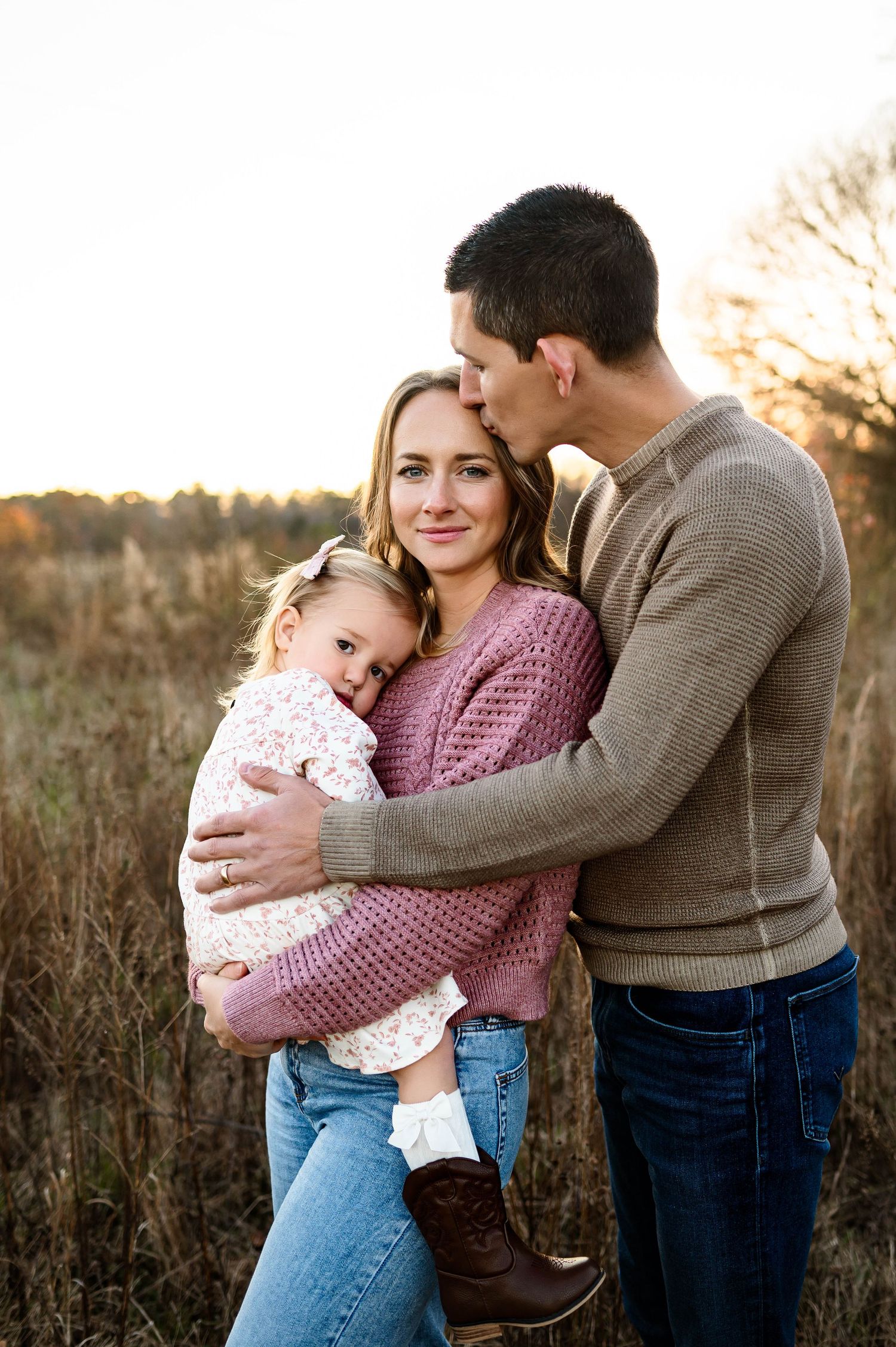 Family cuddling together during a winter outdoor family photography session in Raleigh NC