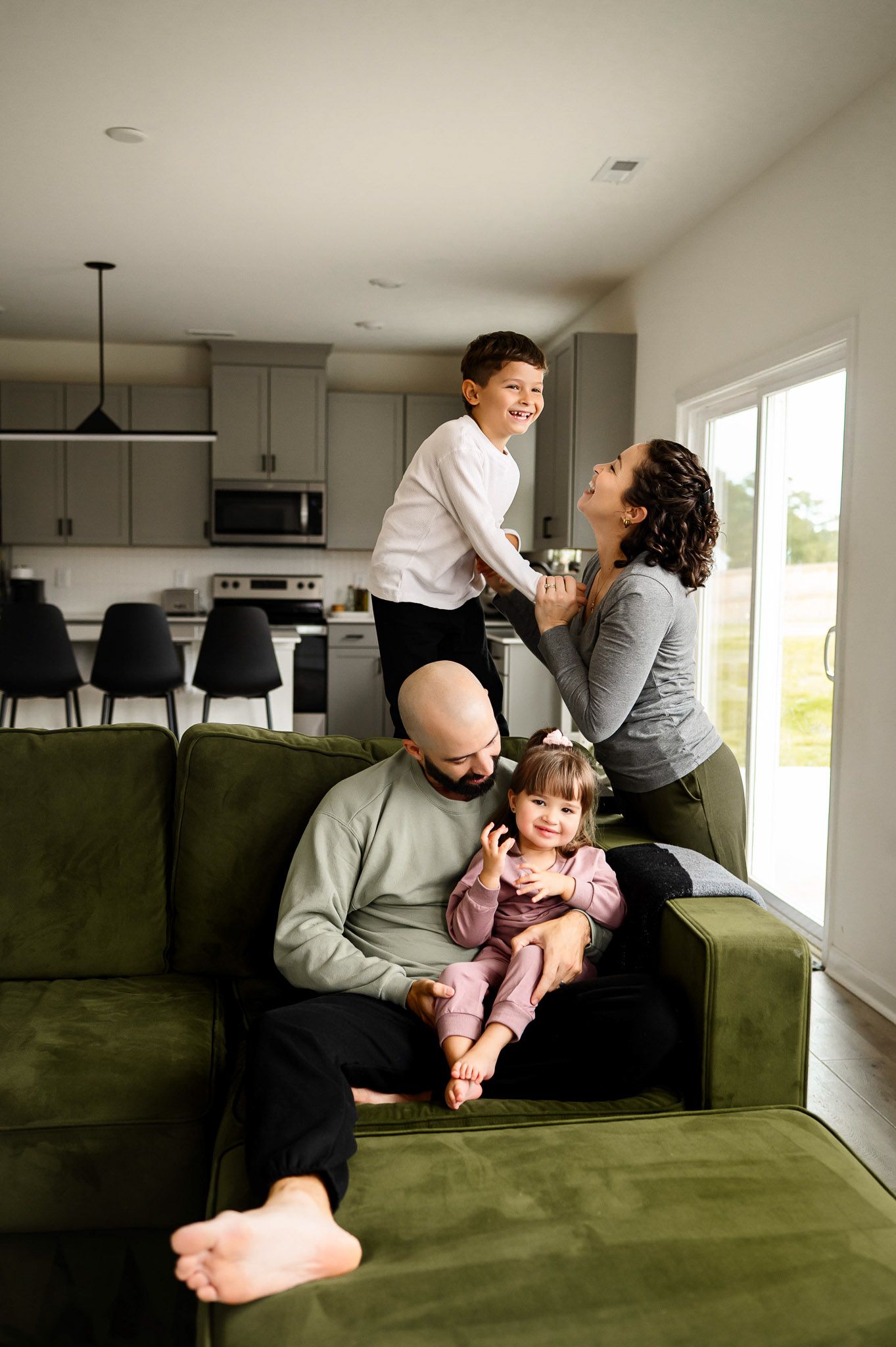Mother and son laughing together during a bright in-home lifestyle family photography session in Raleigh North Carolina