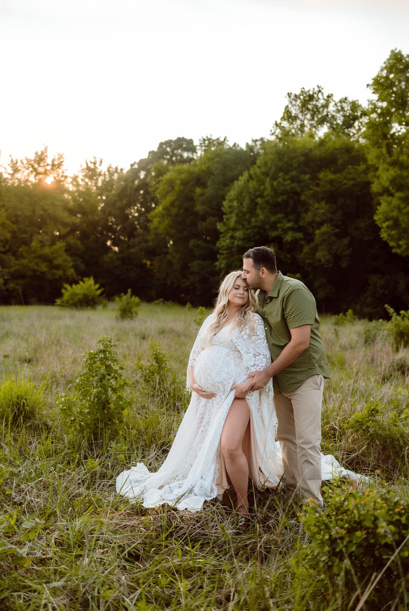 Expectant parents standing together during an outdoor maternity photography session near Wake Forest NC
