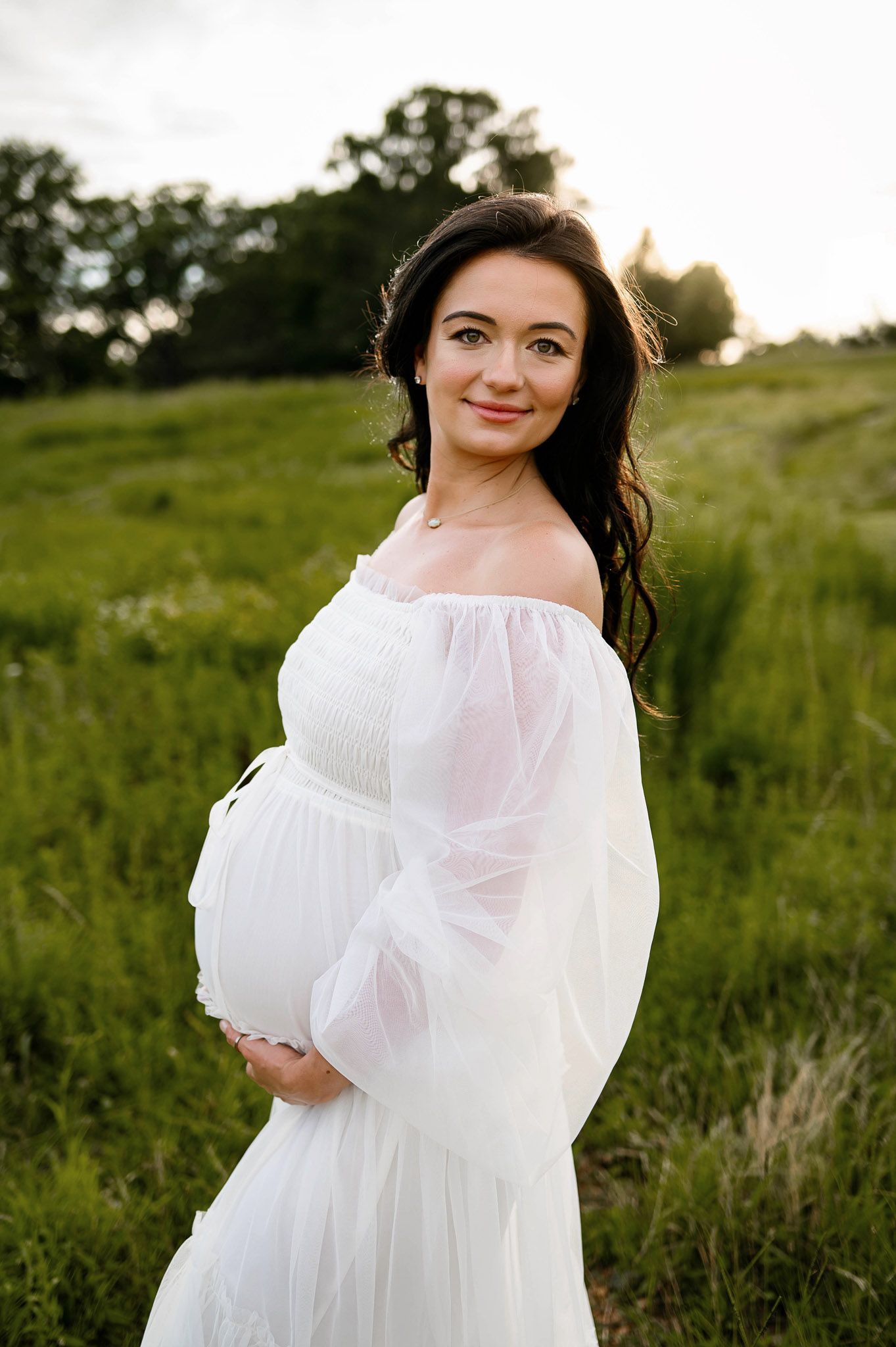 Outdoor maternity portrait of an expectant mother during golden hour in Apex NC