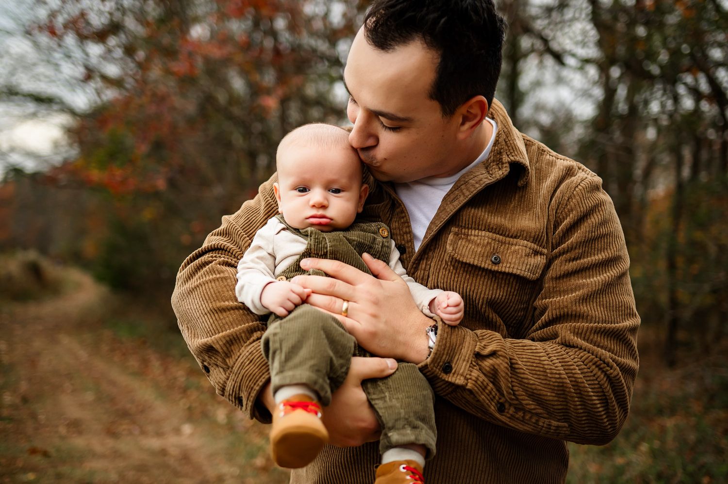 Father kissing his baby during a fall family photography session in Raleigh NC