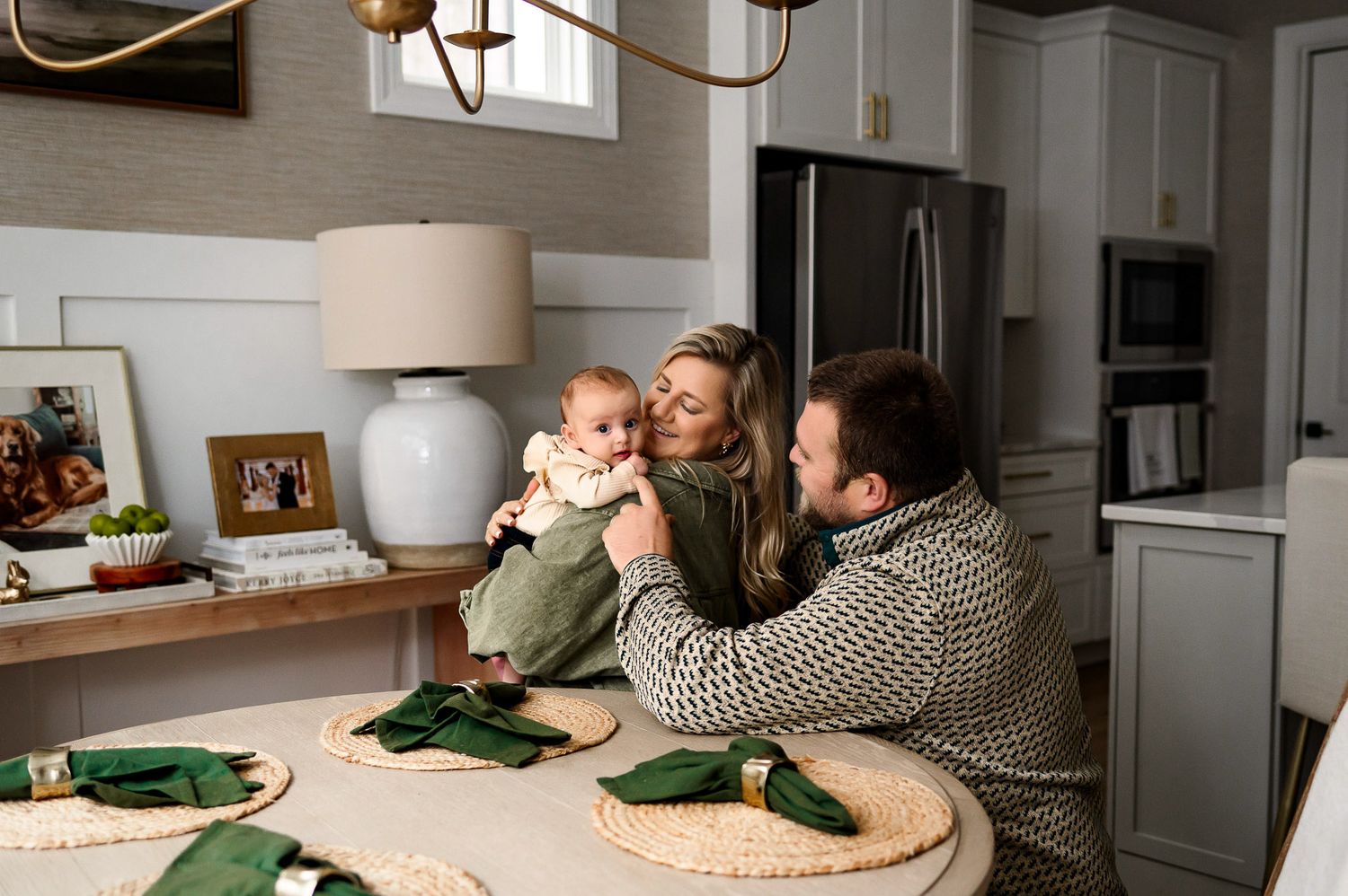 Parents holding baby during natural light in home family photography session in Raleigh NC