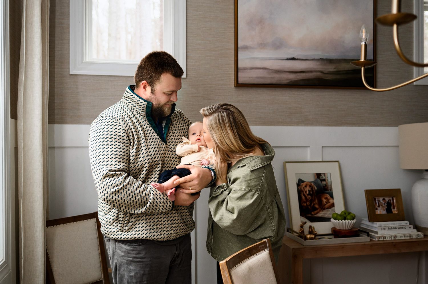 Mother kissing her baby on the cheek during a candid in-home lifestyle family photography session