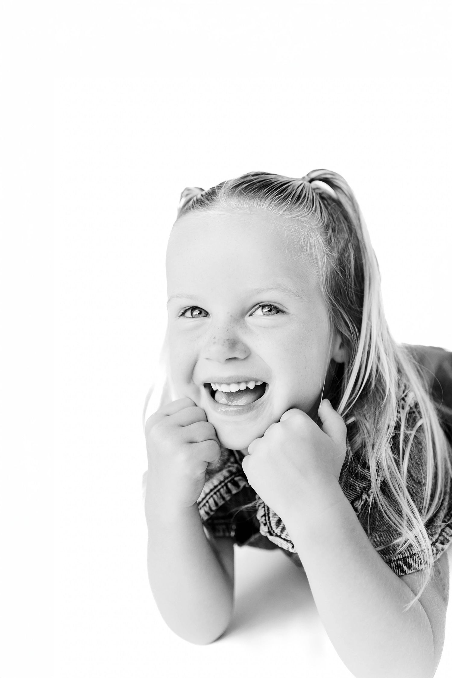Black and white artistic portrait series showing close-up expressions of joy and laughter with Raleigh family photographer