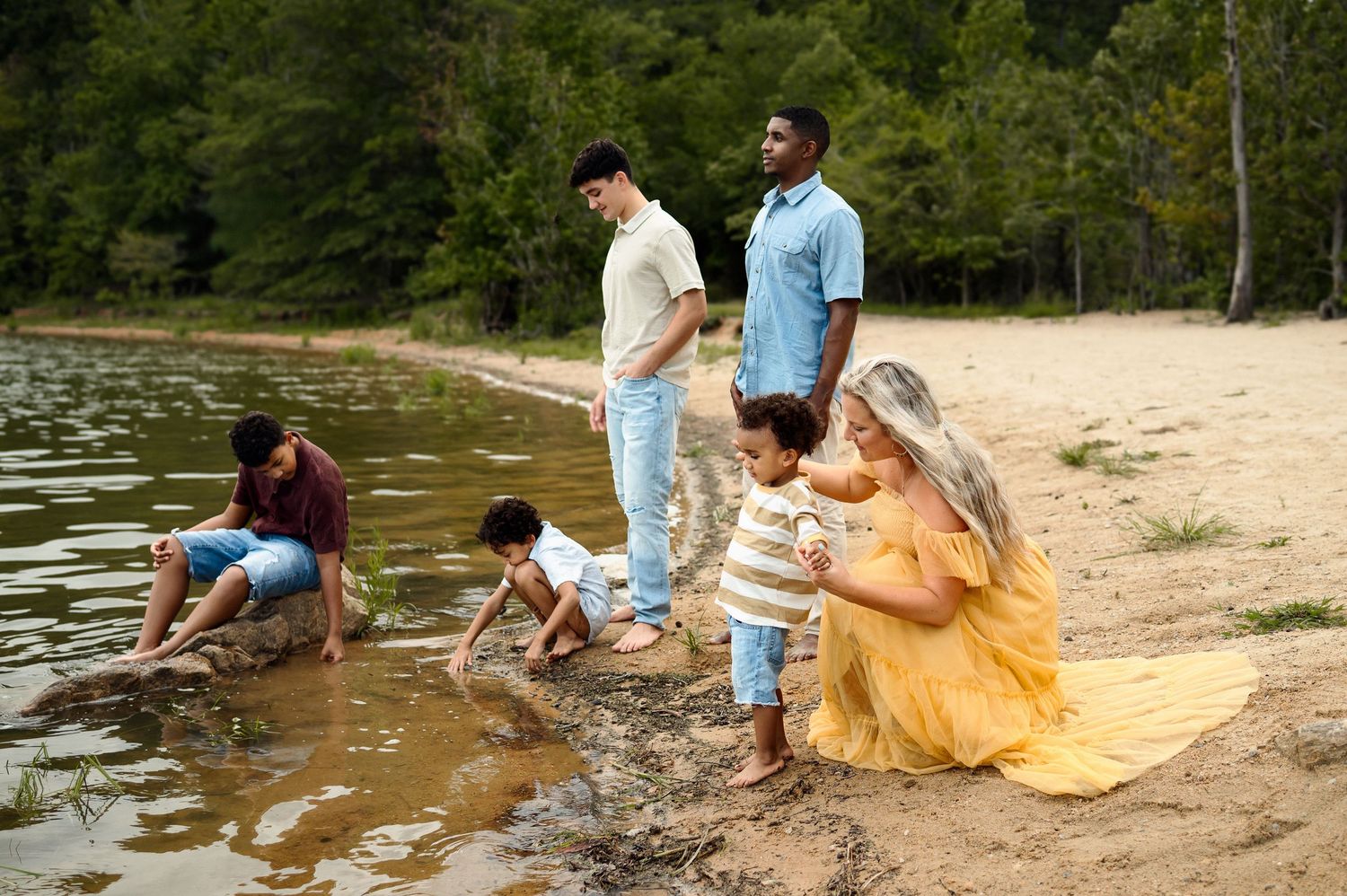 Raleigh family photographer capturing a family playing together along the lakeshore during a relaxed outdoor photography session