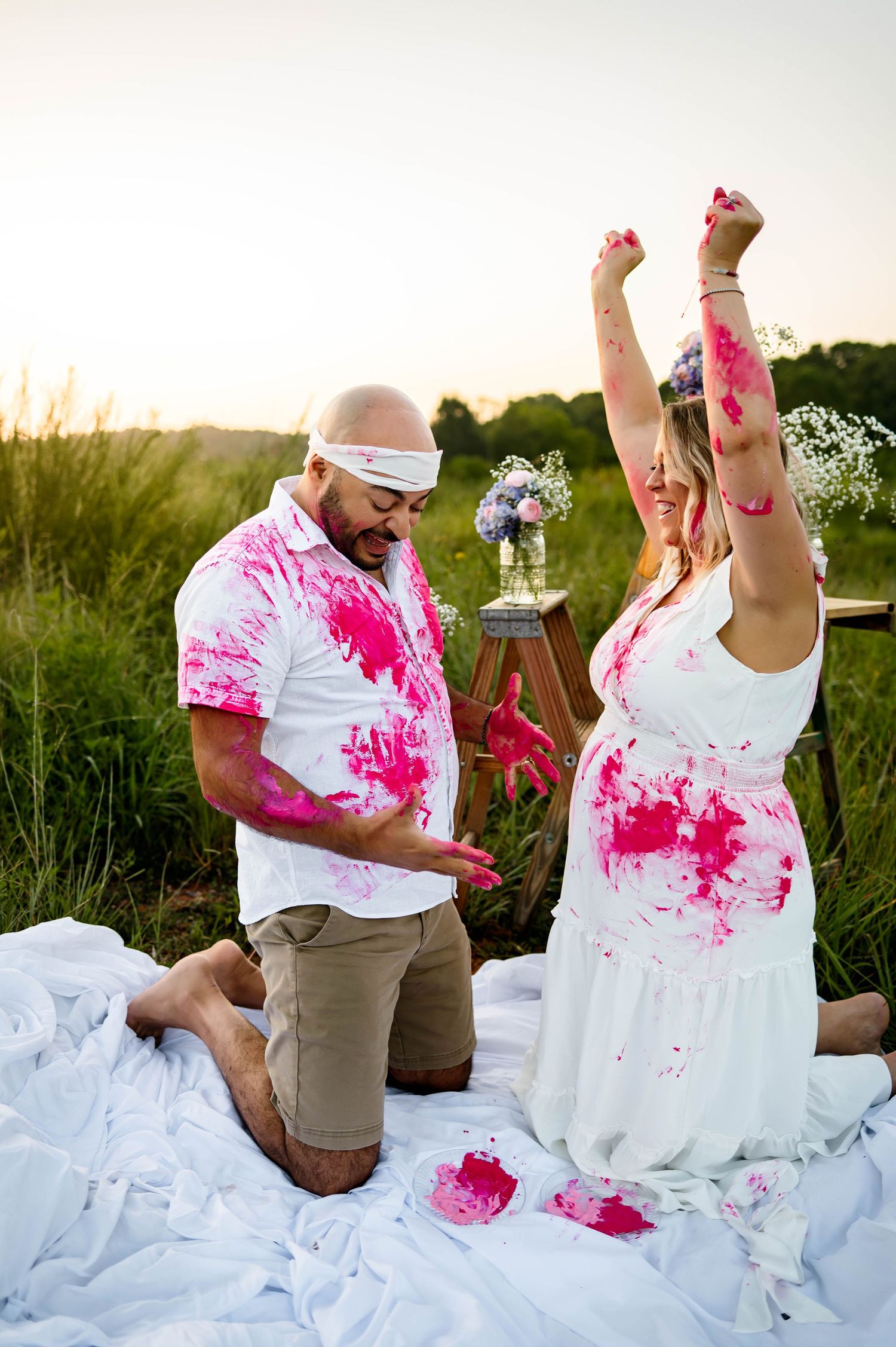 Parents celebrate during their gender reveal photography session after learning they are having a daughter with Raleigh family photographer