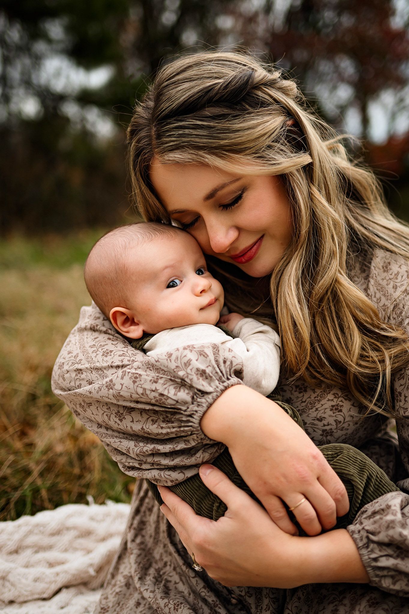 Mother cuddling her baby during a natural outdoor fall family photography session in Raleigh NC
