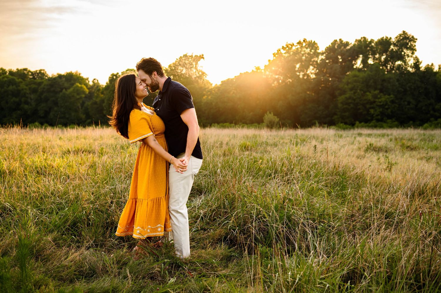 Couple holding hands and leaning in during a golden hour family photography session at sunset in Raleigh