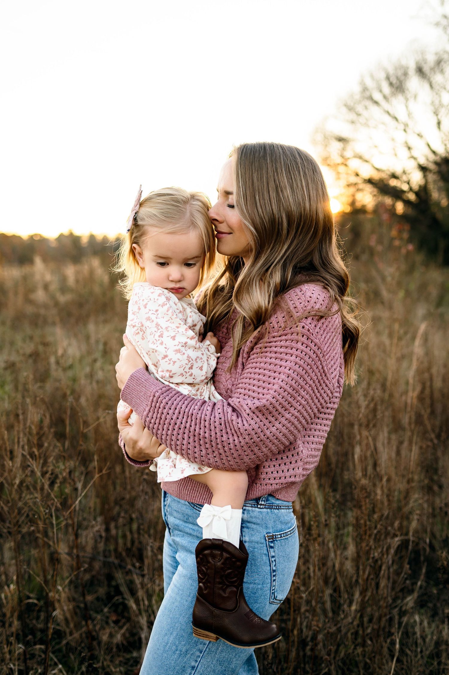 Mother holding her toddler during a winter outdoor family photography session in Raleigh NC