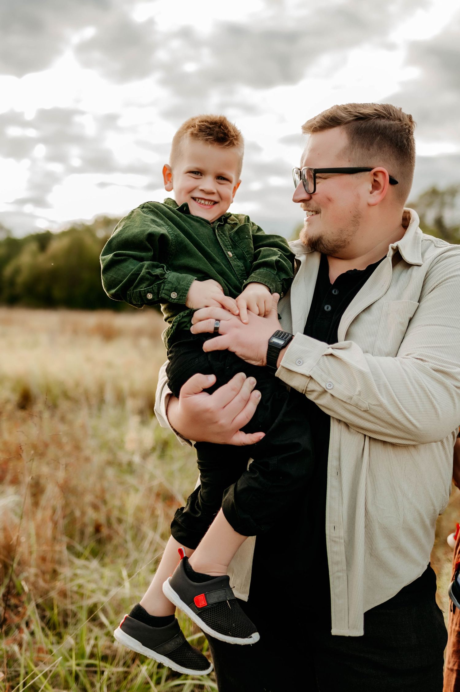 Emma Branch captures a father holding his young son during a family photography session in Raleigh NC
