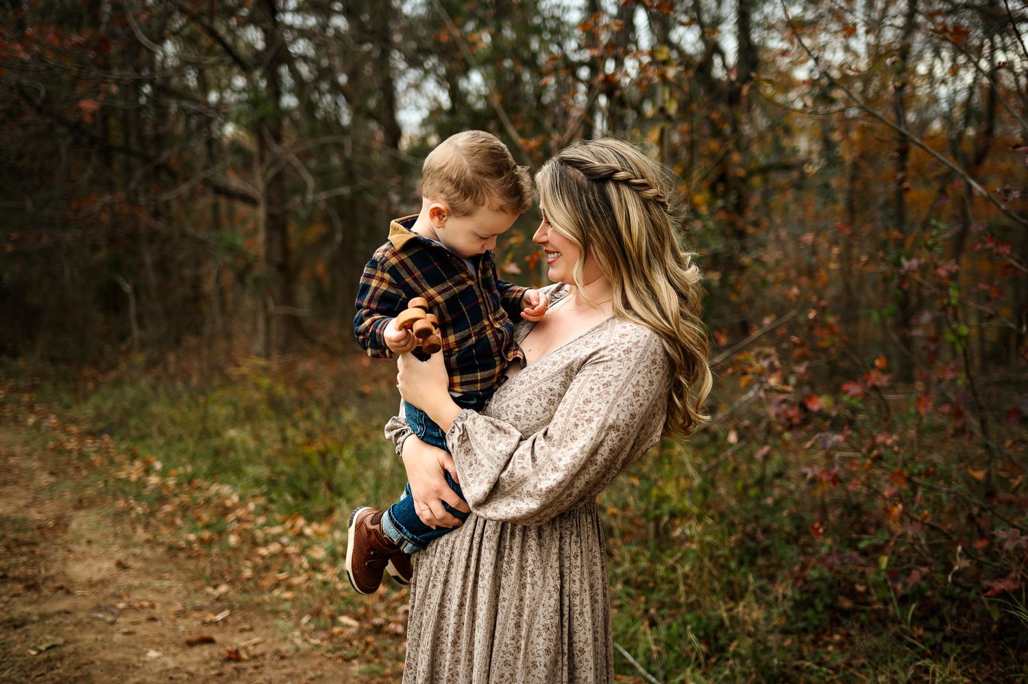Mother holding her toddler during a relaxed fall family photography session in Raleigh North Carolina
