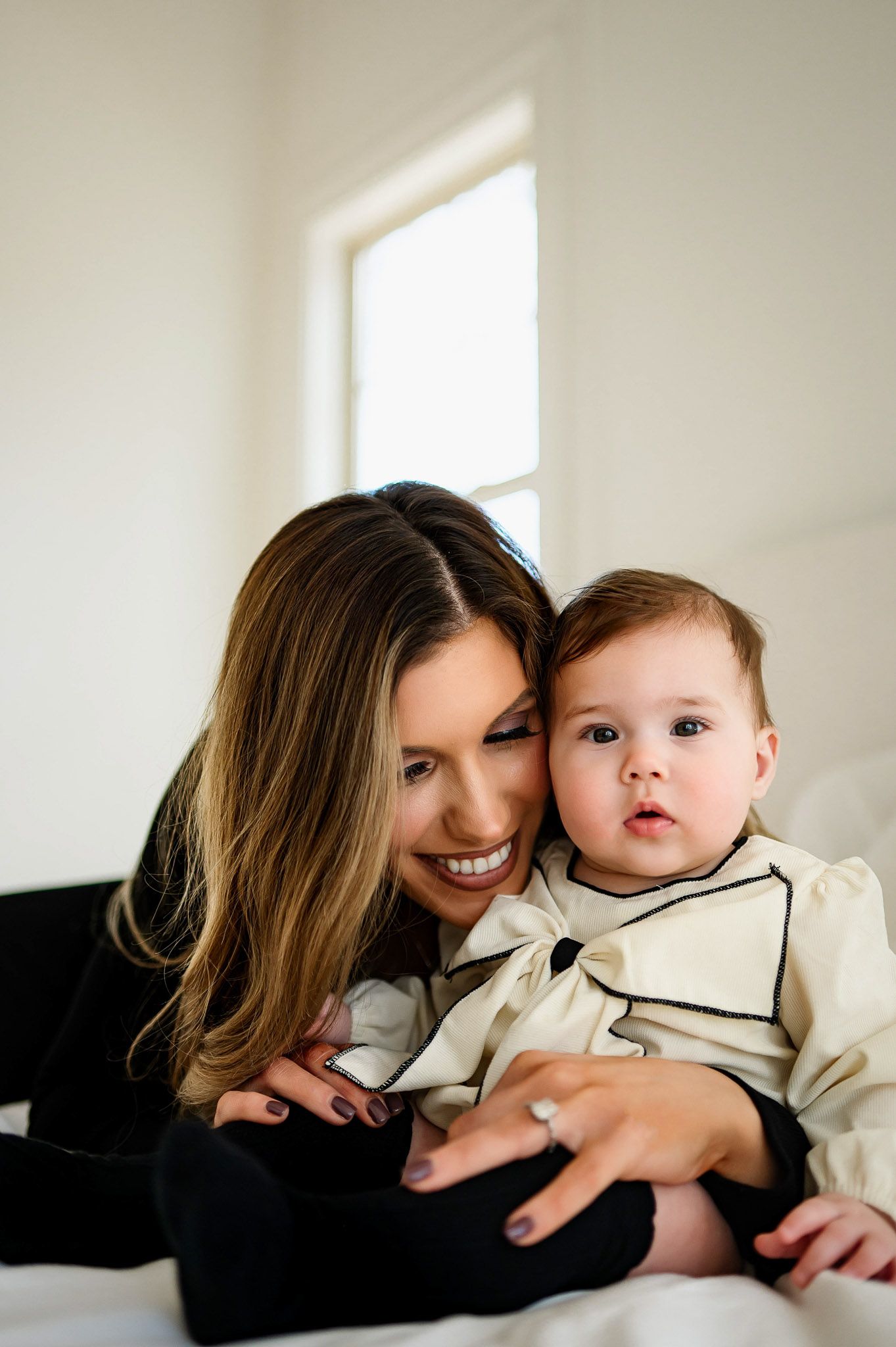 Mother cuddling her baby during a relaxed in-home lifestyle family photography session