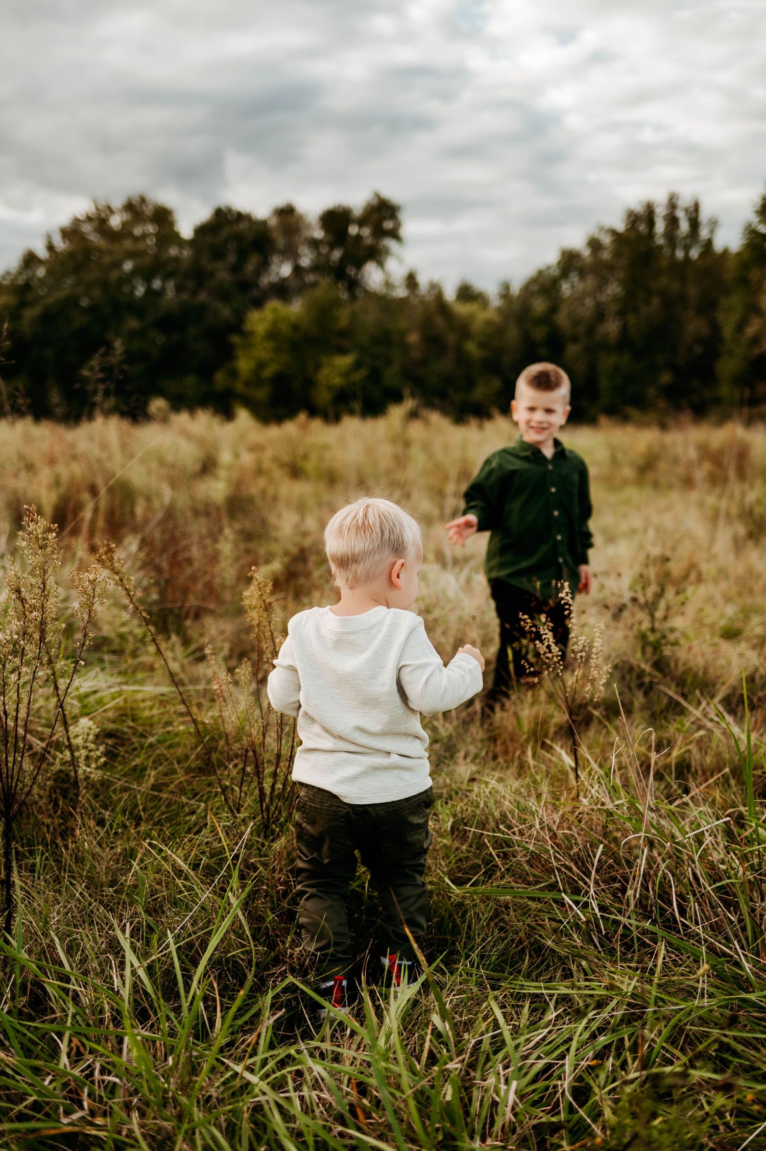 Two young brothers walking together during a fall family photography session with the best Raleigh family photographer