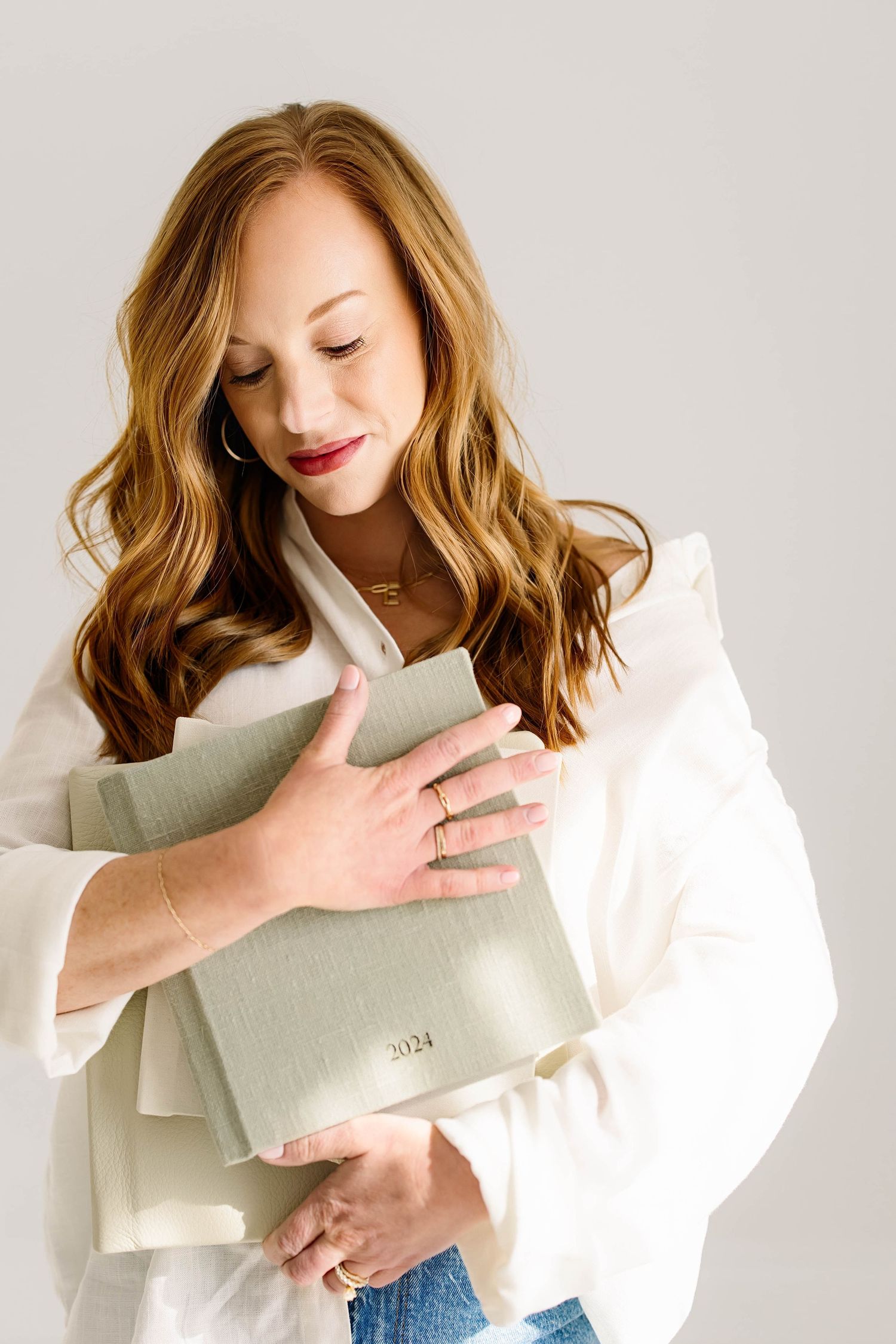 Raleigh family photographer holding a custom linen Legacy Album designed to preserve family memories.