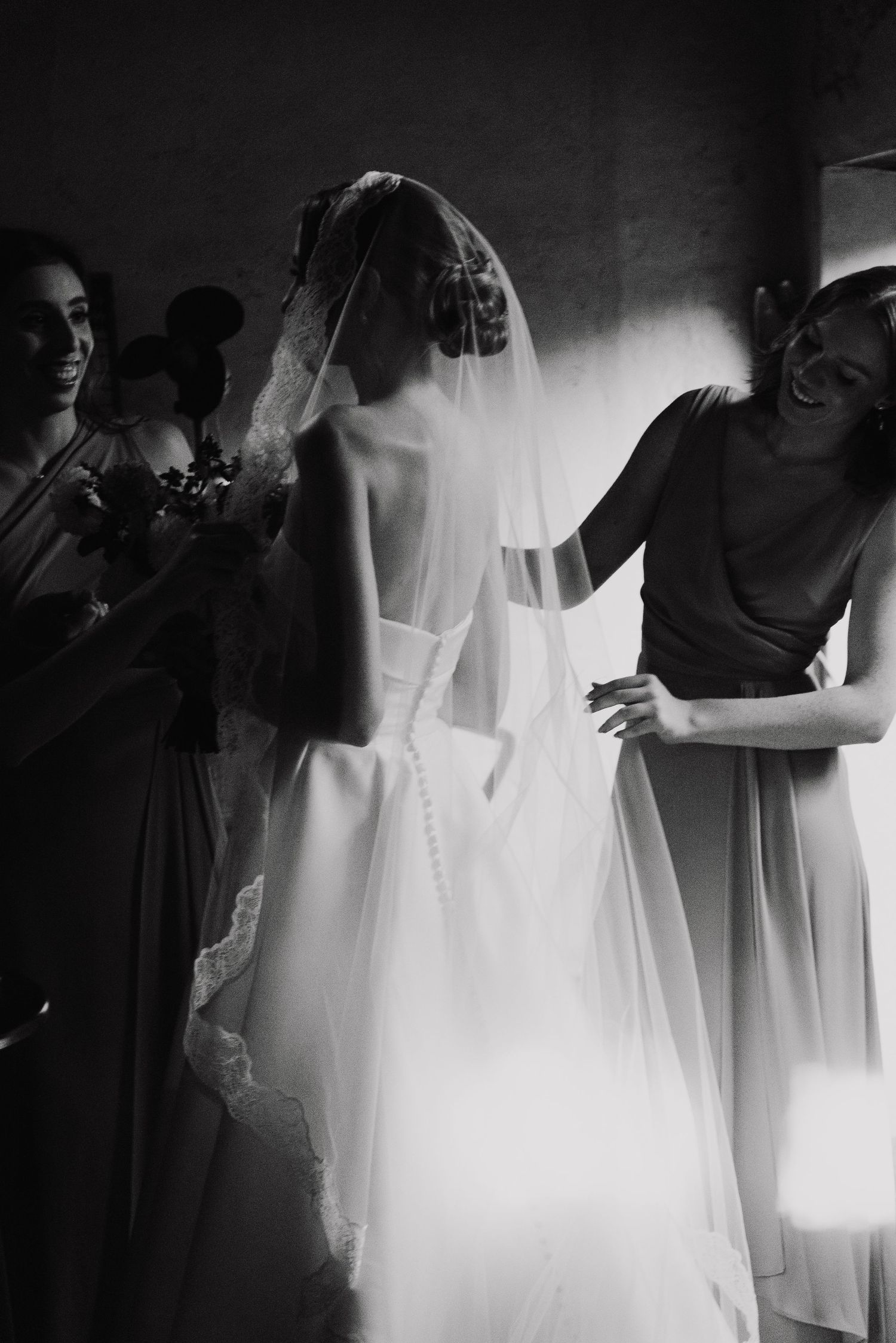 Black and white image series showing the delicate preparation of a wedding veil in soft natural light.