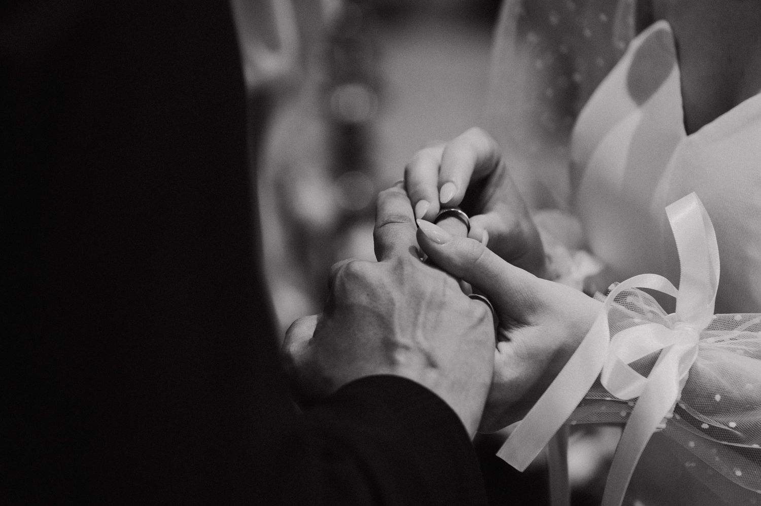 Delicate floral bouquet arrangement held by hands in soft focus.