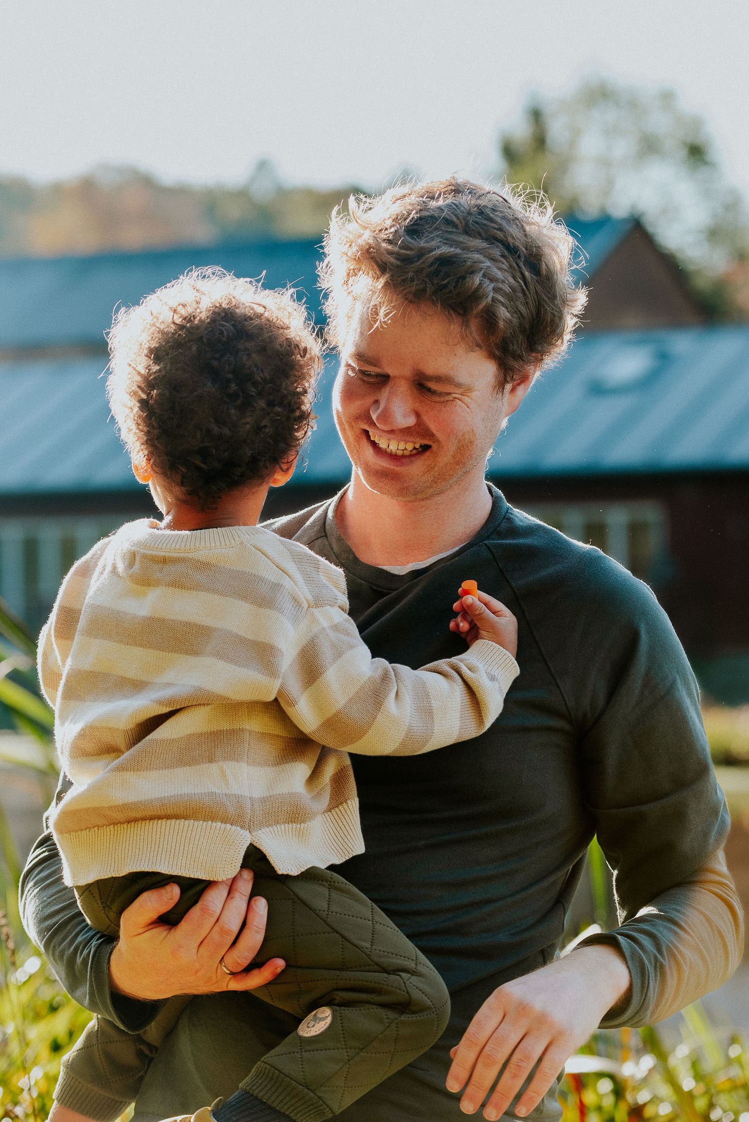 A heartwarming sequence of outdoor moments between a parent and child in warm sunlight.