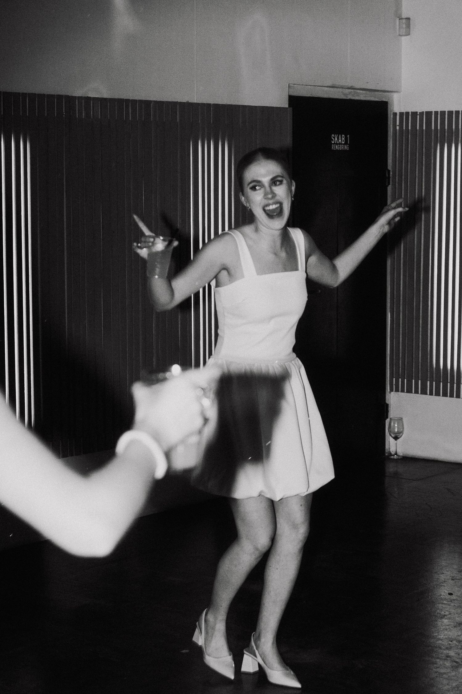 Black and white photos capturing dynamic dance movements in a minimalist indoor space.