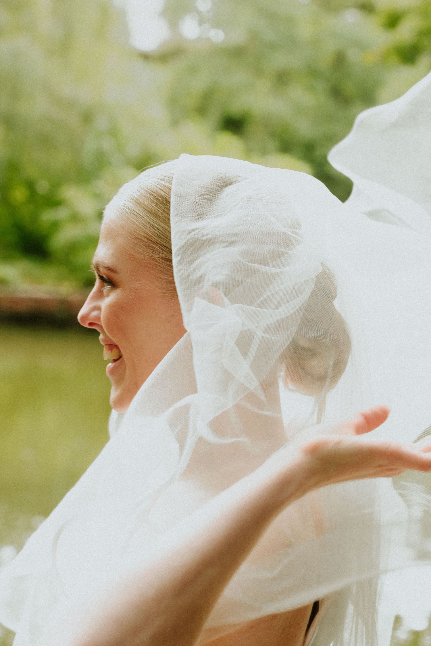 Candid wedding photos capturing joyful moments with a flowing white veil against a natural background.