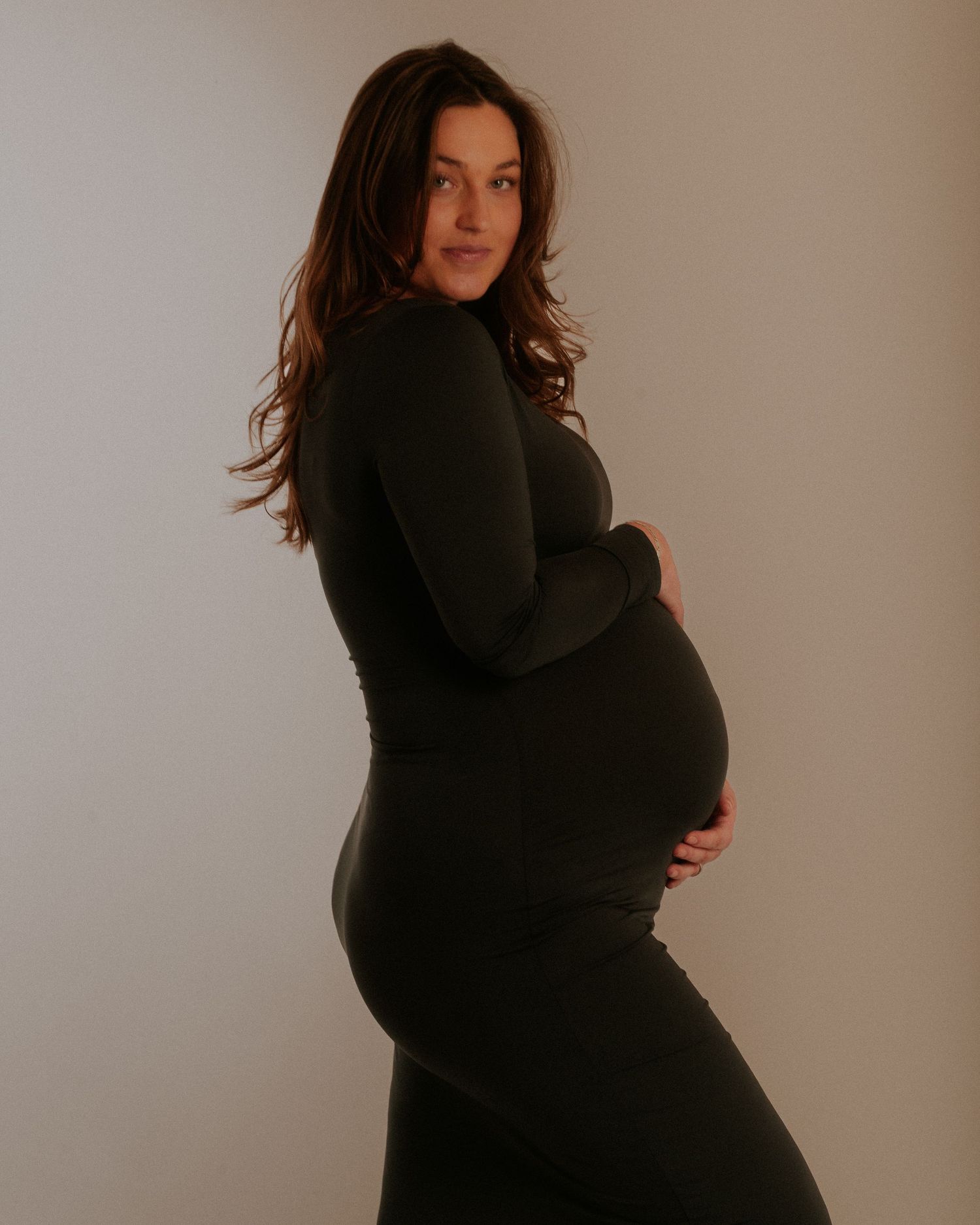 A figure in a black turtleneck sweater poses against a neutral backdrop in a series of artistic portraits.