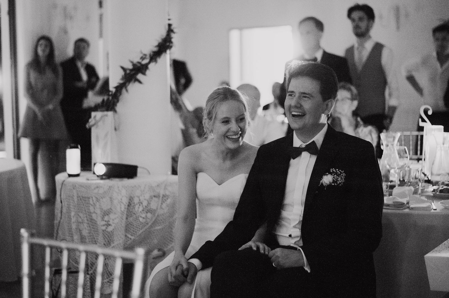 Wedding reception candid moments captured in black and white photography.