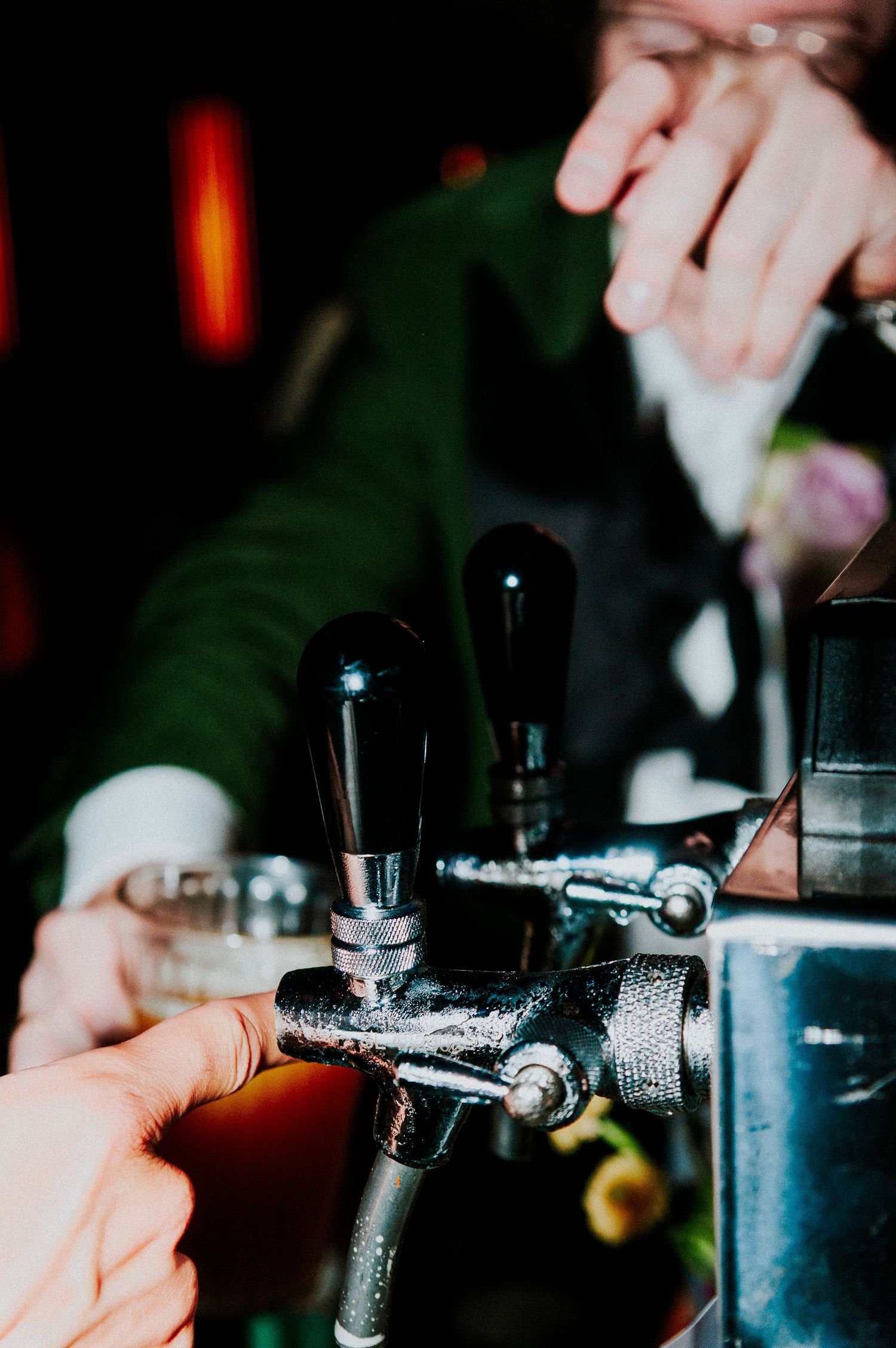 Close-up of beer tap handles at wedding reception bar service.