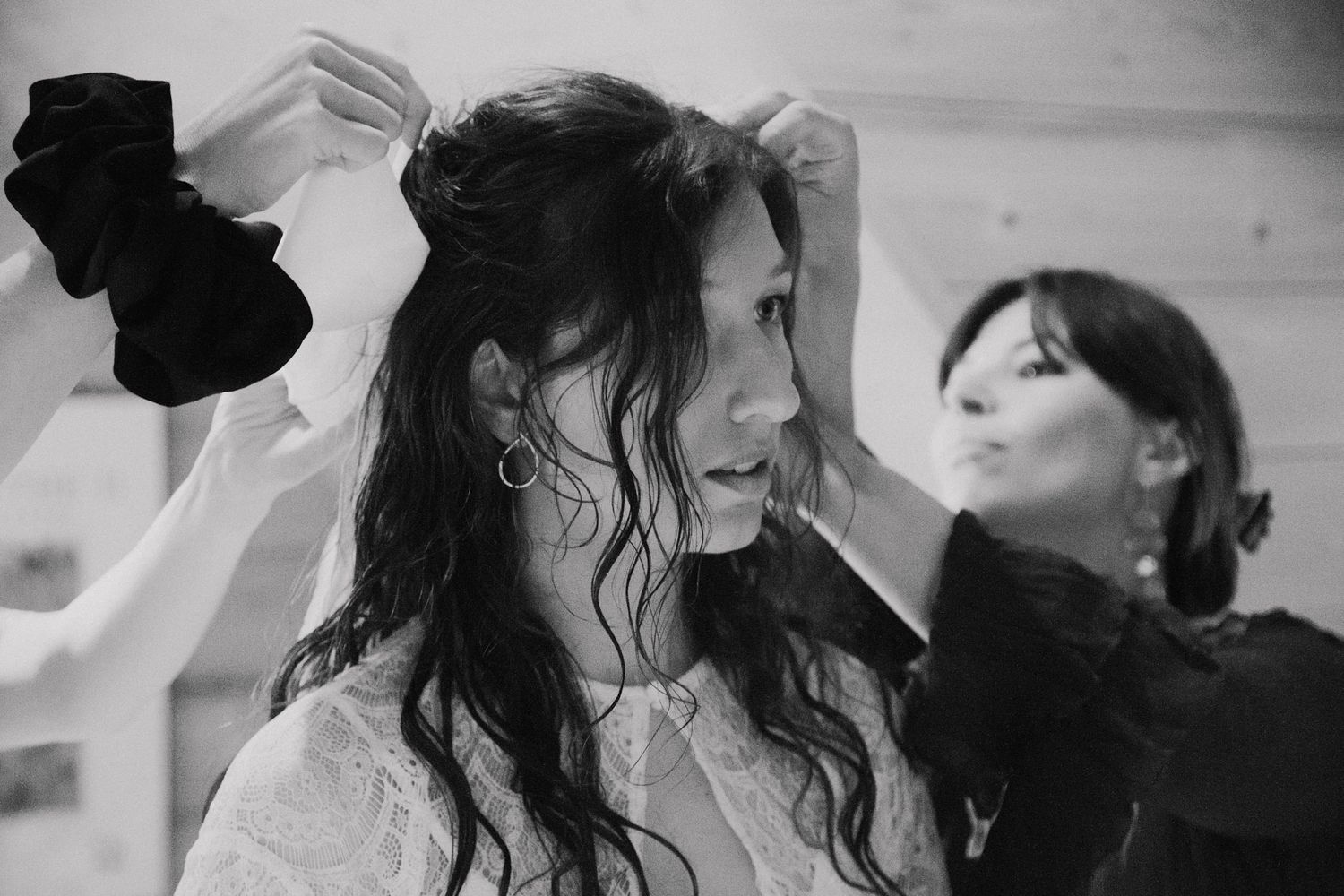 Black and white image of bridal hair styling preparation.