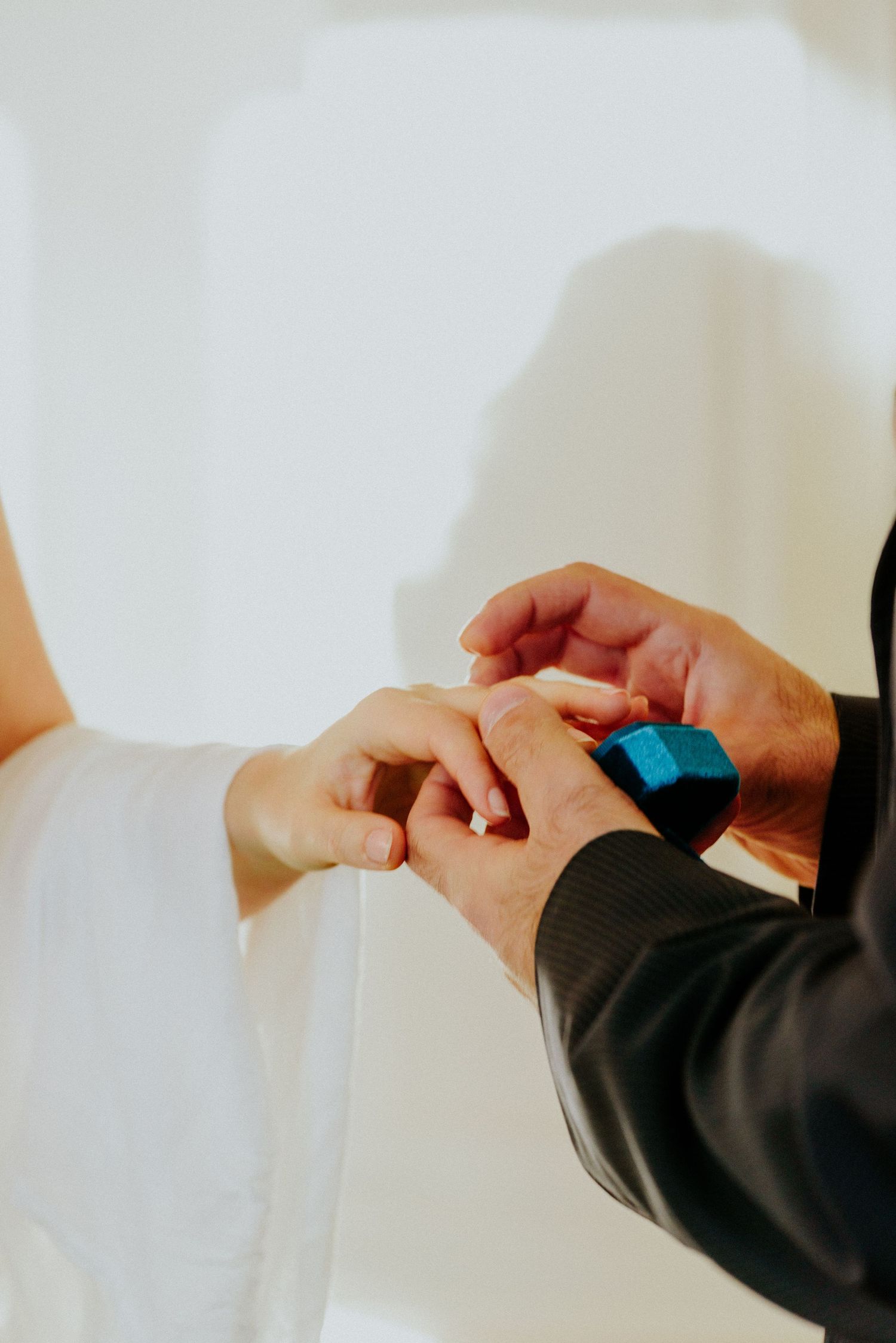 Close-up sequence of hands exchanging rings during an intimate wedding ceremony.