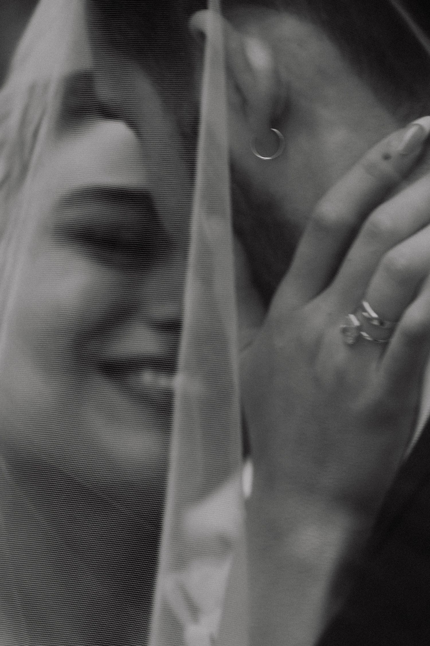 A black and white close-up photograph shows two people sharing an intimate kiss in a romantic moment.