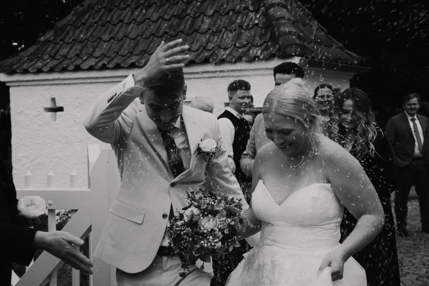 Black and white candid wedding celebration photos showing joyful moments.