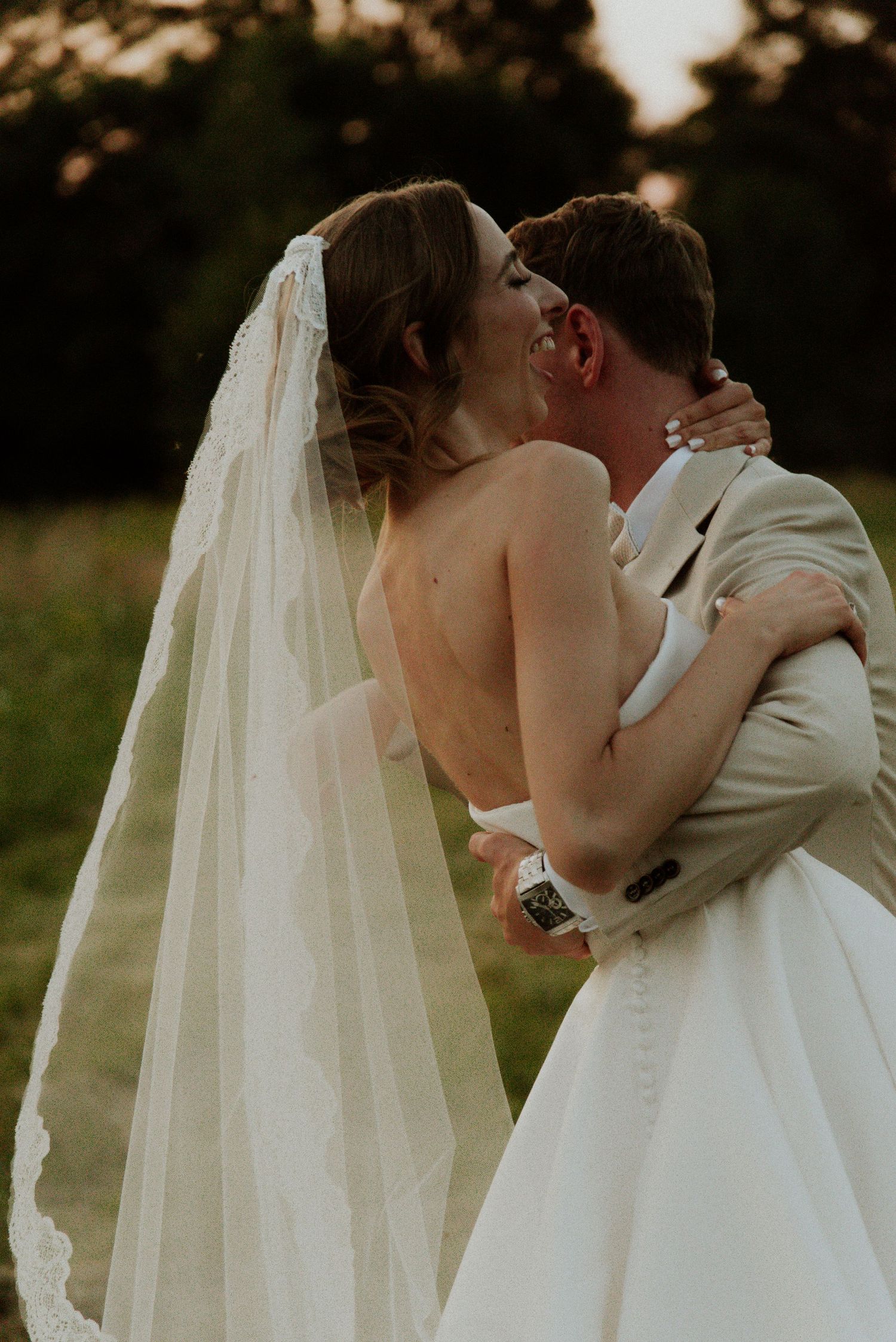 A romantic wedding moment captured in a sequence of intimate embraces between a couple in white attire outdoors.