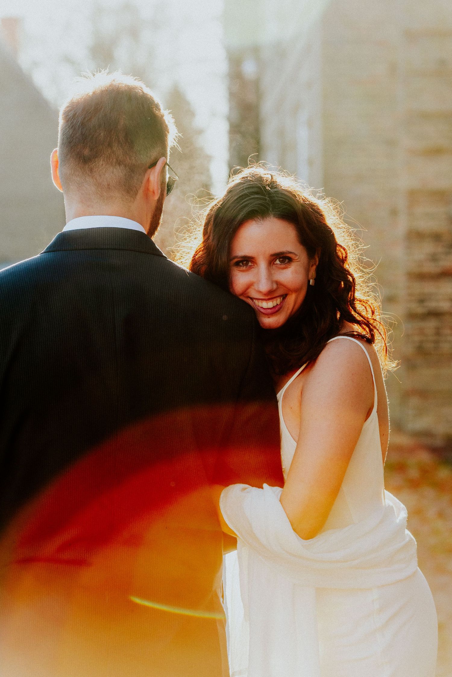 A series of romantic sunset wedding photos showing a couple embracing in warm golden light.