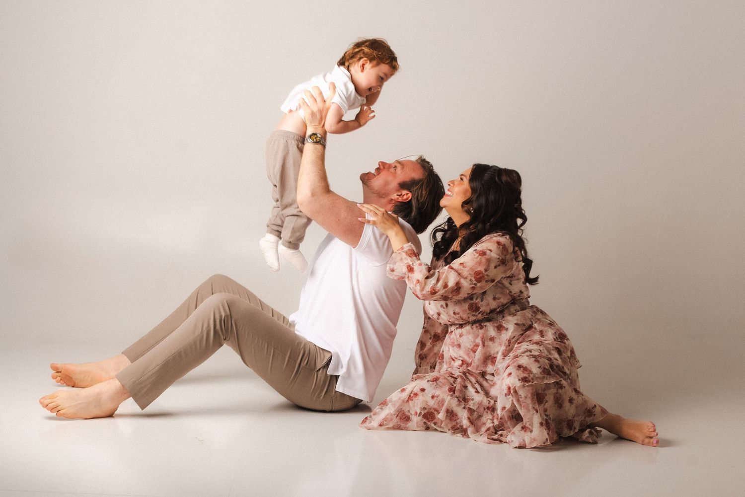 A tender moment captured in a series of intimate poses against a light gray backdrop.