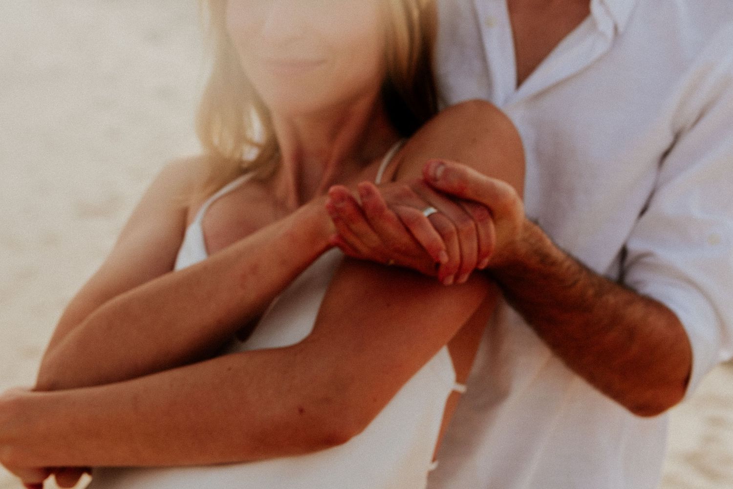 Close up of hands receiving a therapeutic massage treatment on arm and forearm muscles.
